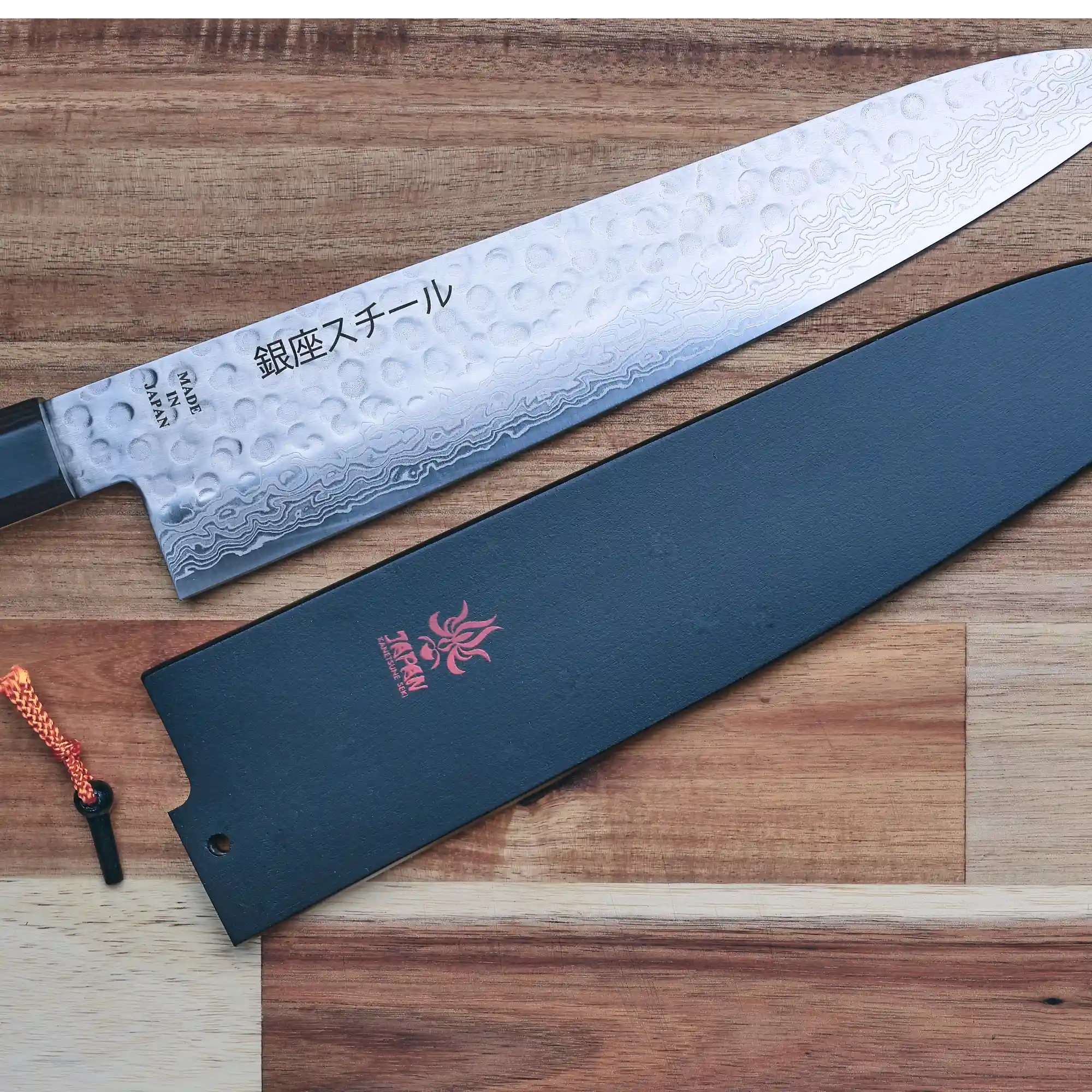 The Ultimate Guide to Knife Guards: Protecting Your Precious Blades - A knife with a protective guard on a wooden surface.