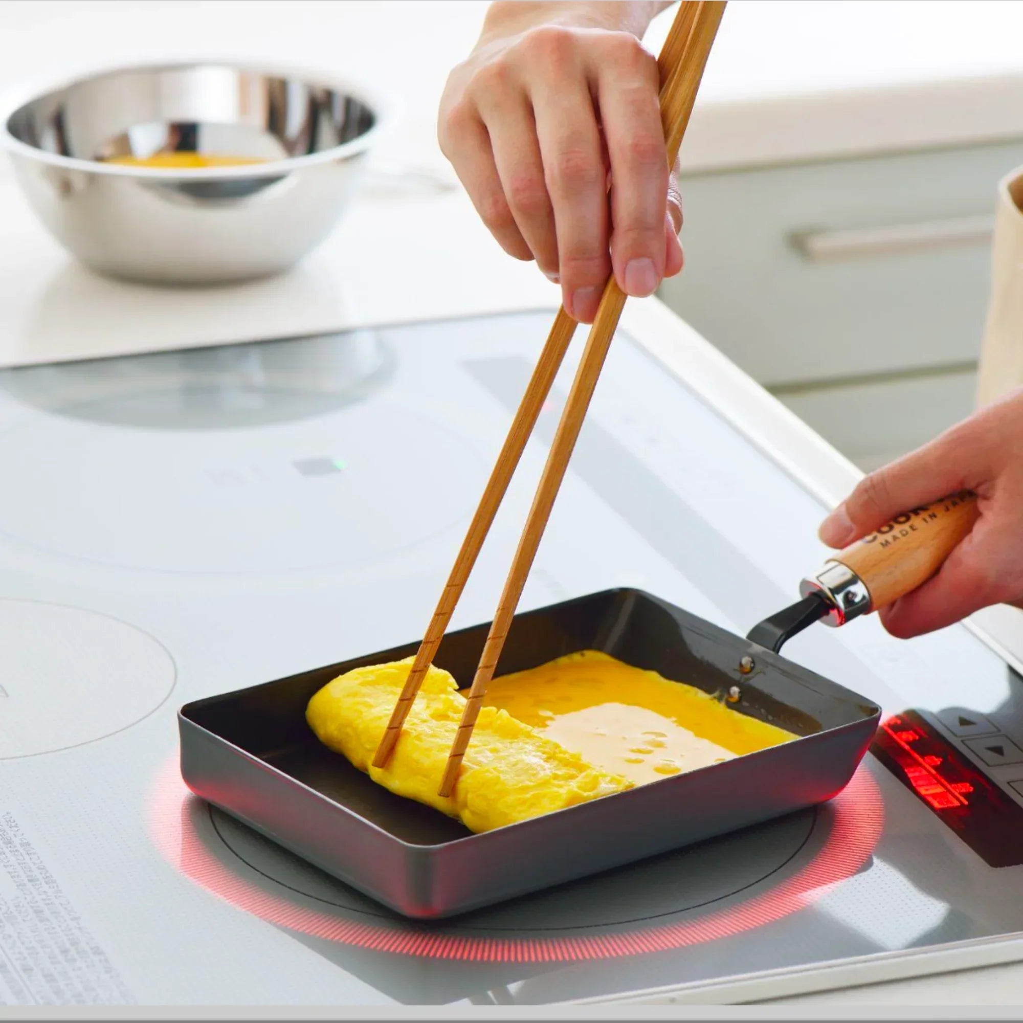 How to Make Tamagoyaki (Tamago) – Japanese Omelette Using Yoshikawa Cook-Pal cooking with chopsticks on a stovetop.