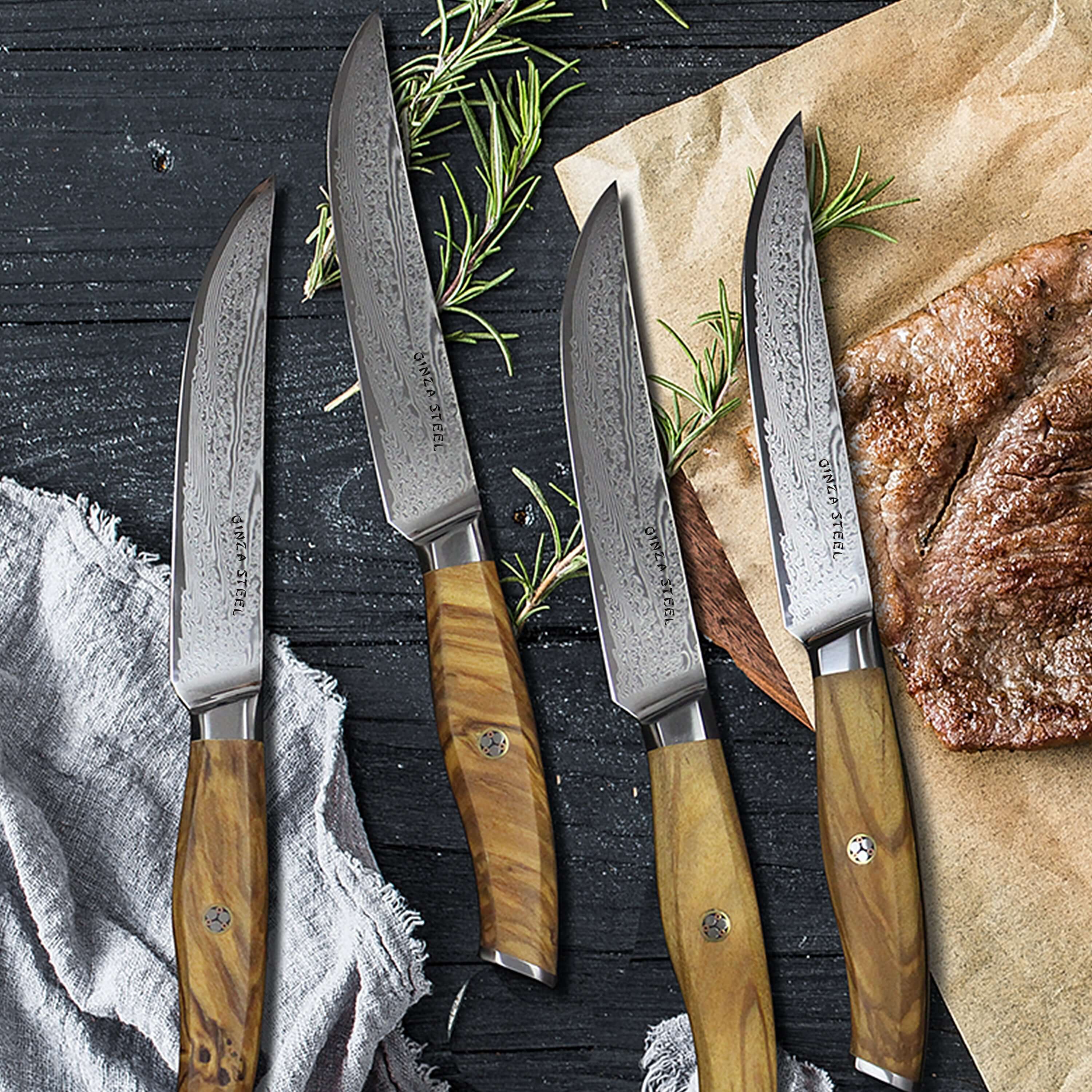 Set of Damascus Steel Steak Knives displayed with rosemary and steak on wooden table.