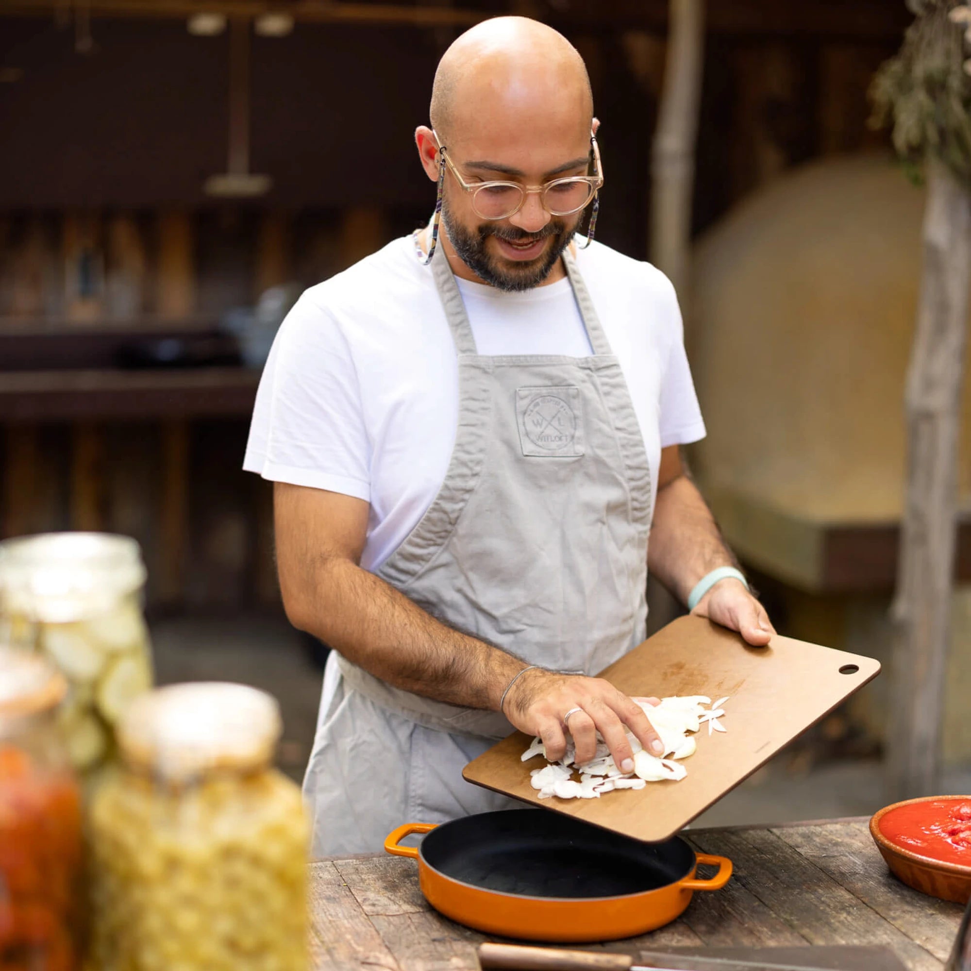 Premium Cutting Boards for Every Kitchen - Chef slicing food on a wooden cutting board.