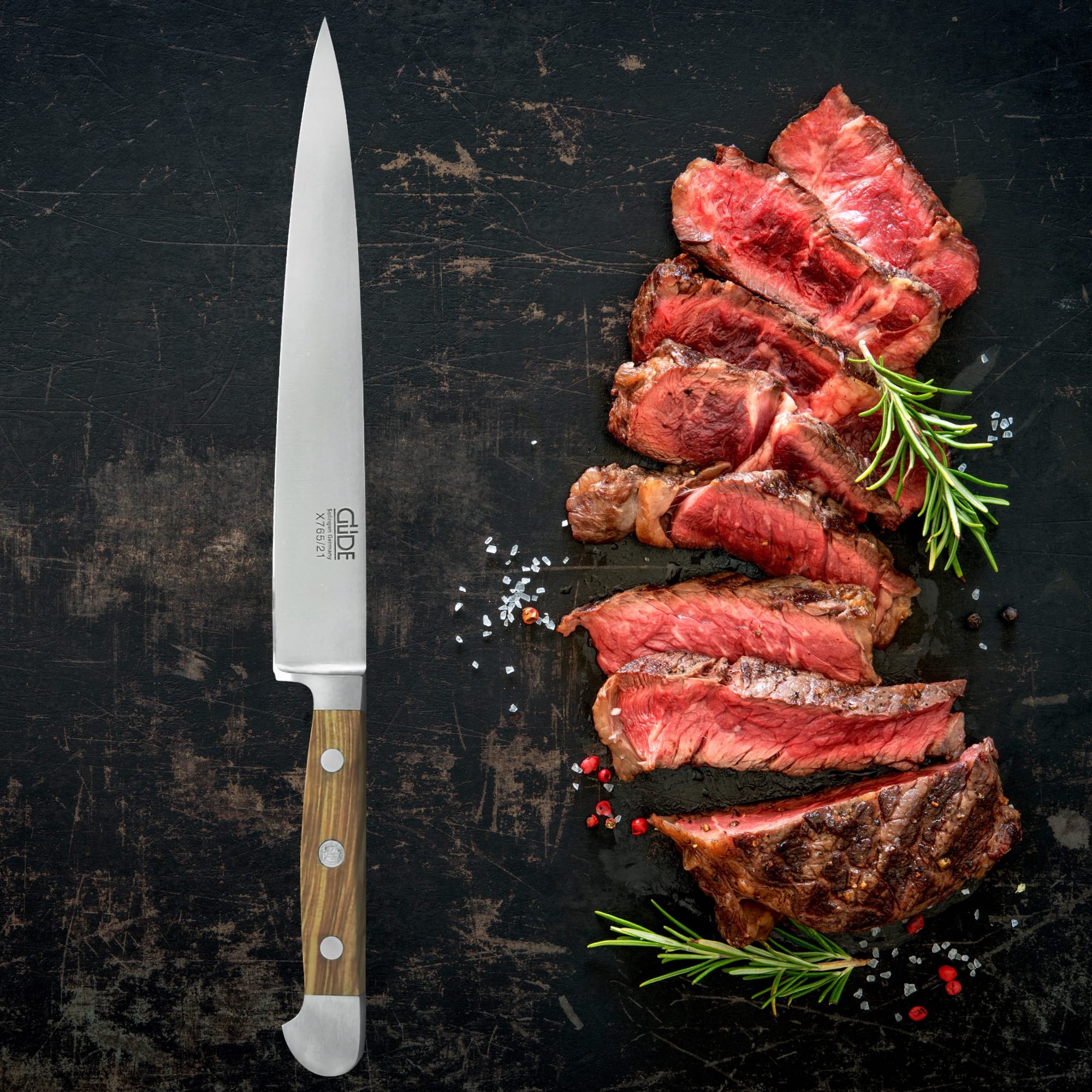 Forged steel carving knife beside perfectly sliced meat, showcasing the quality of forged steel carving knives and forks.