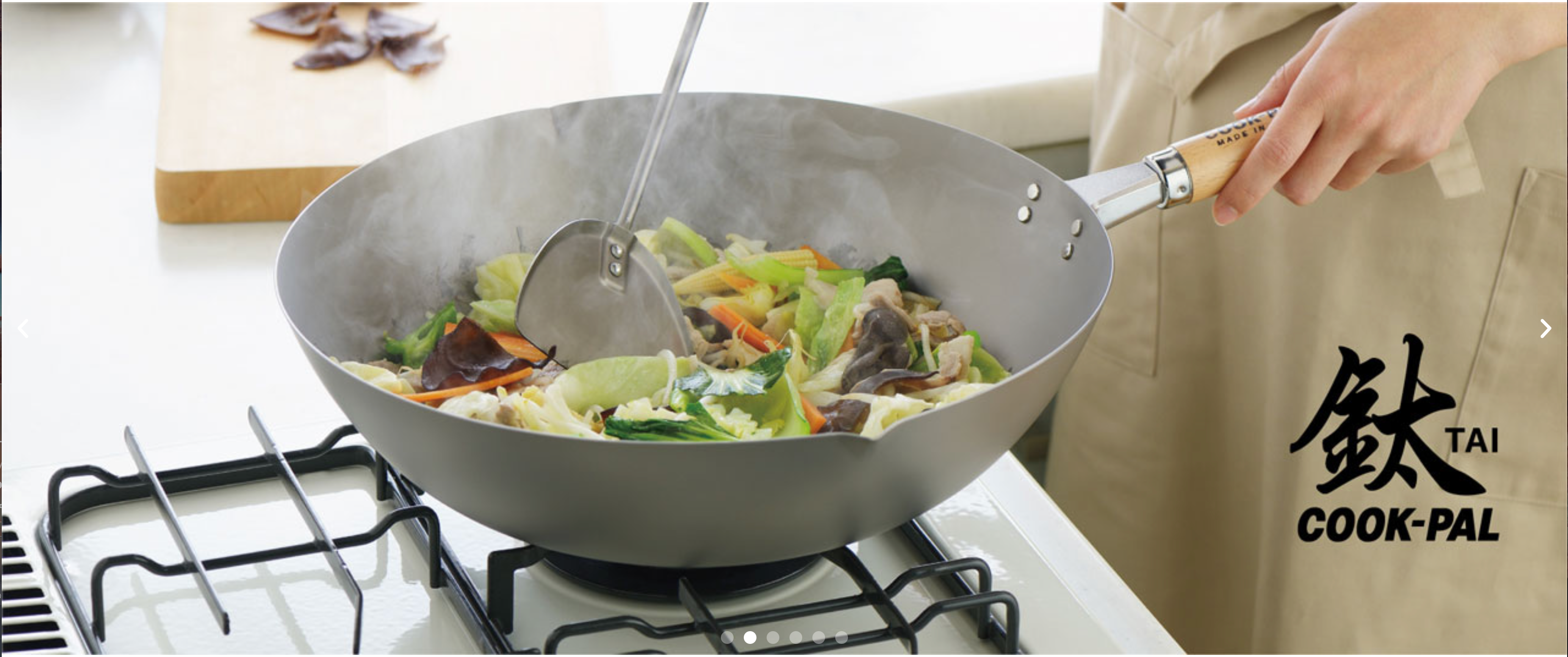 Chef using Yoshikawa Titanium Wok on a gas stove for stir-fry