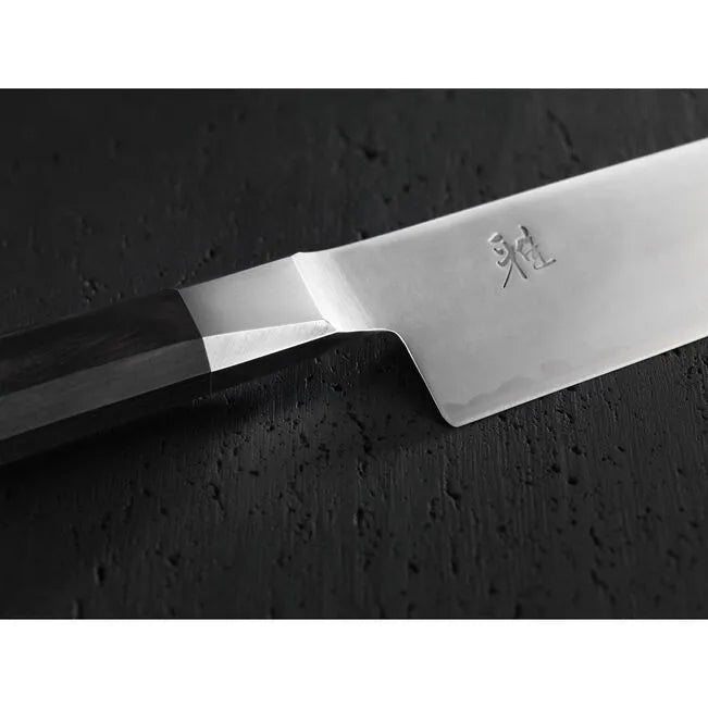 Knife with a brand logo on a dark textured surface