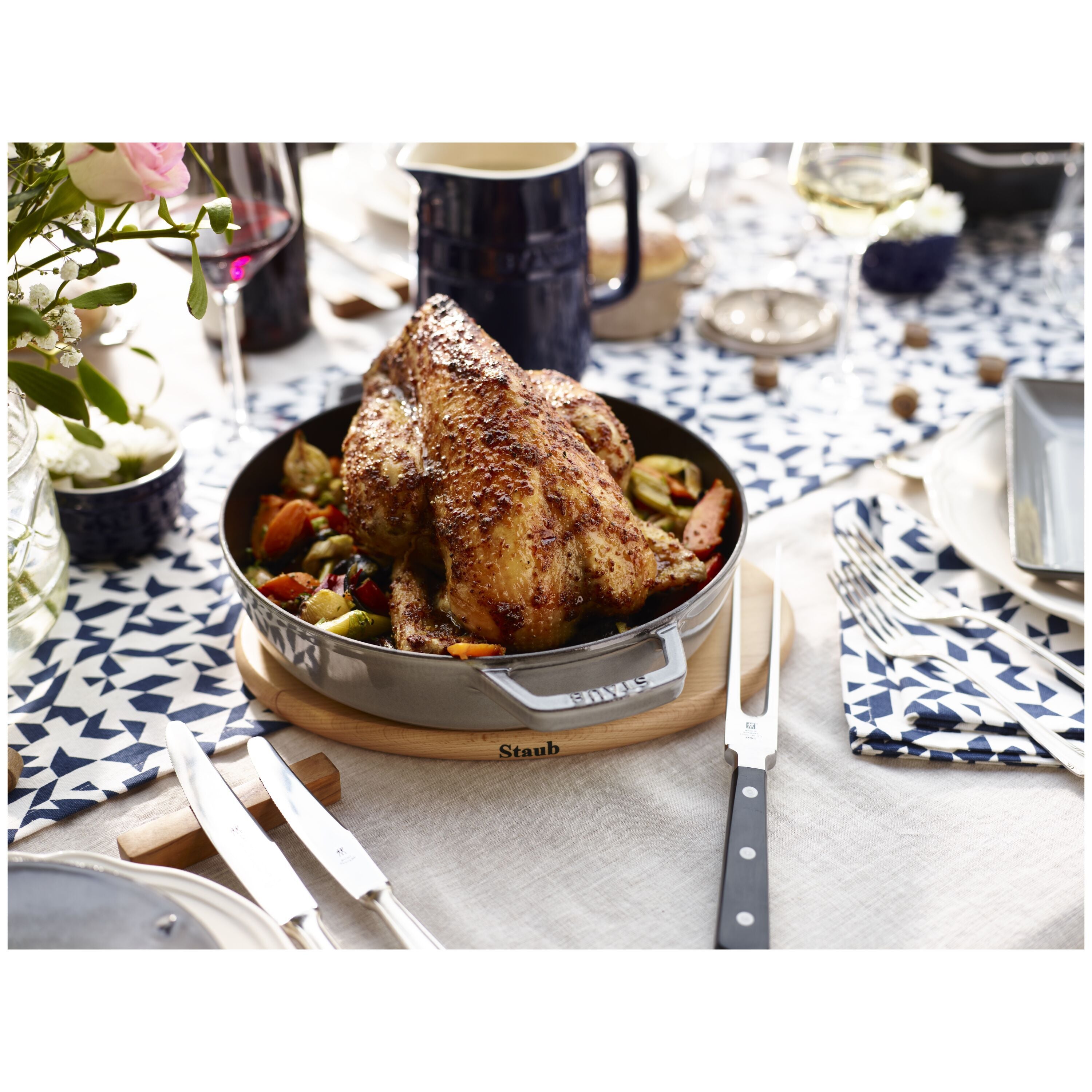 Delicious roasted chicken on a STAUB Specialities Oval Beech Trivet Magnetic, perfect for elegant dining.