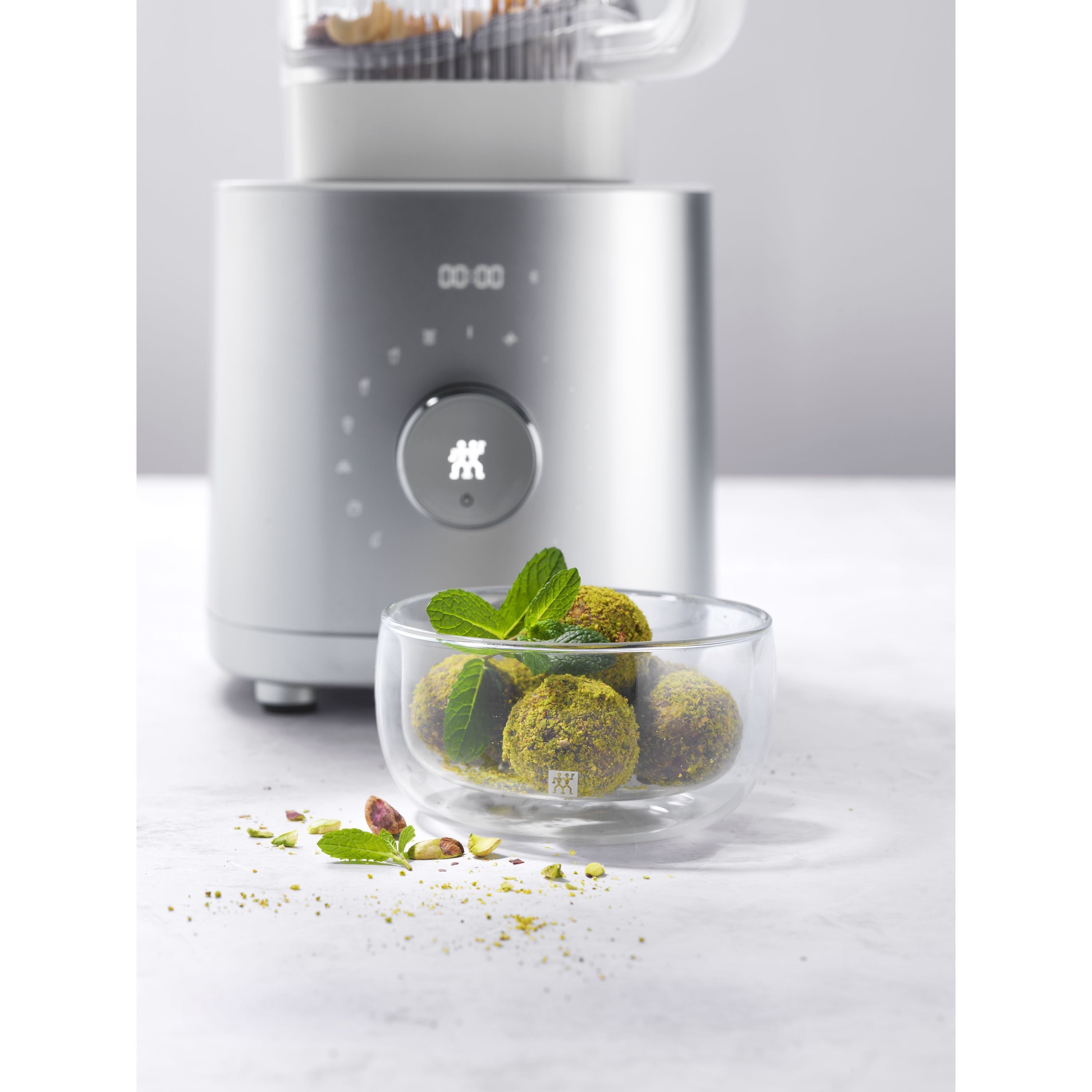 ZWILLING Enfinigy Power Blender Pro with Small food processor with a bowl of green food on a white background