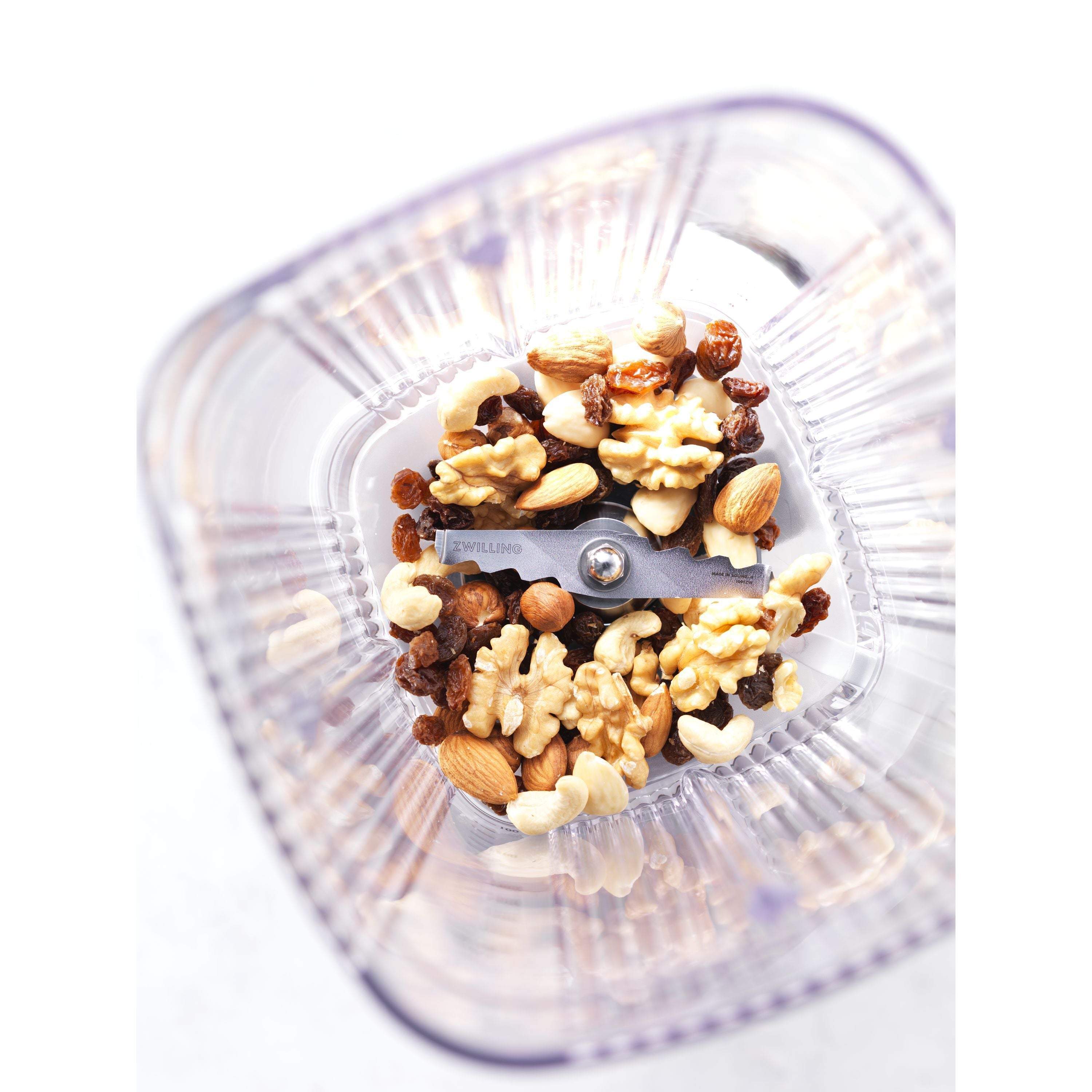 ZWILLING Enfinigy Power Blender Pro container with mixed nuts on a white background