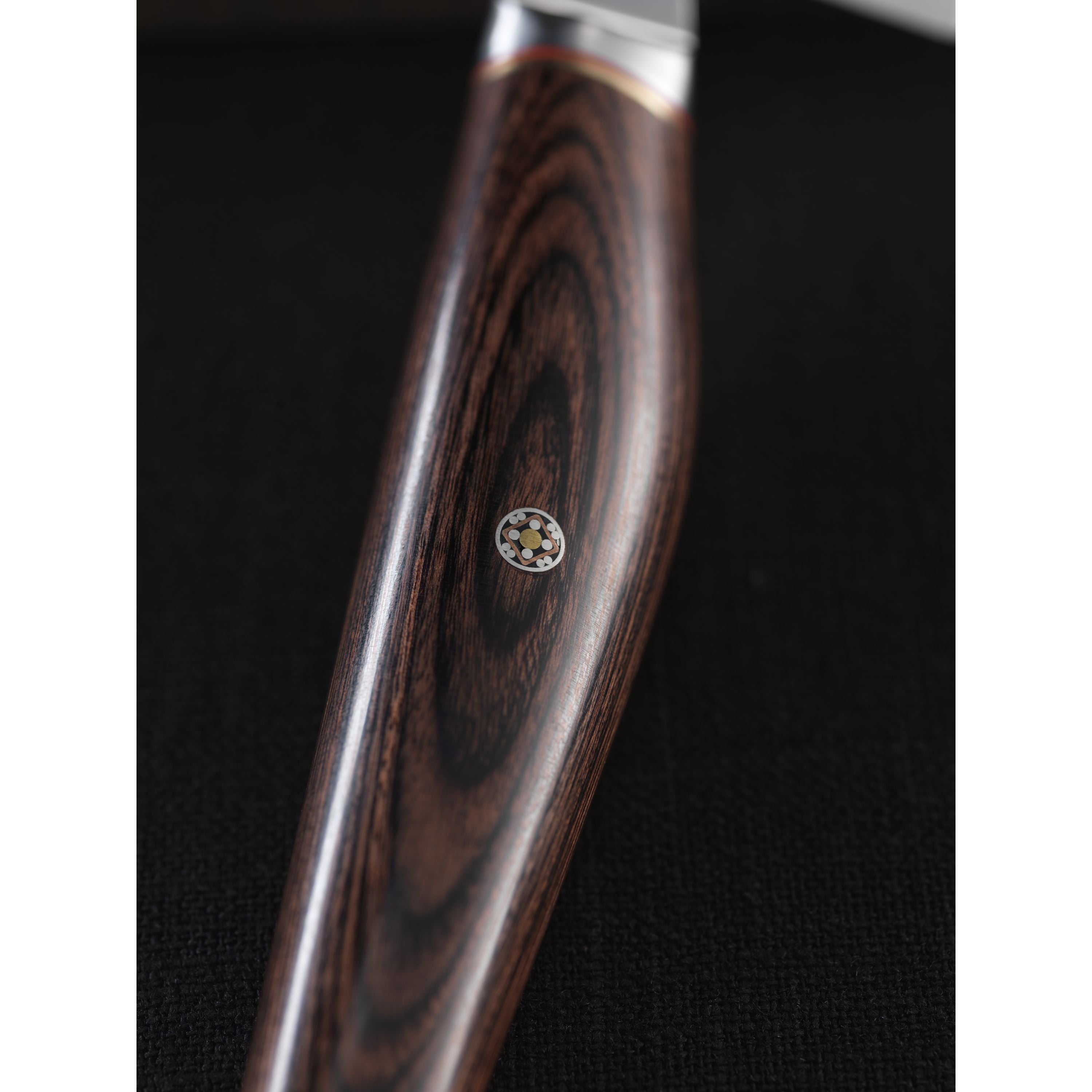 Wooden handle with a metallic tip on a dark background