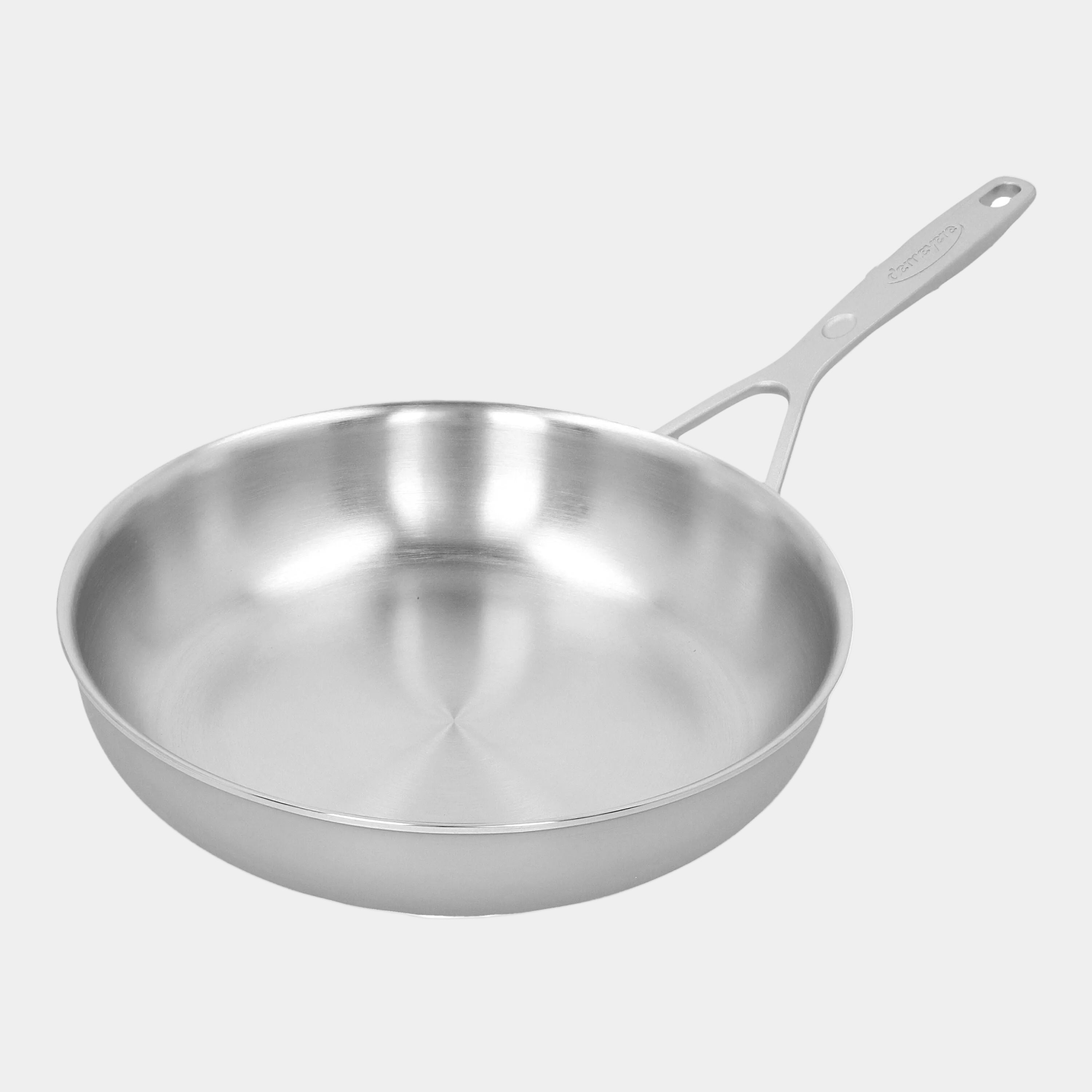 Stainless steel frying pan on a white background
