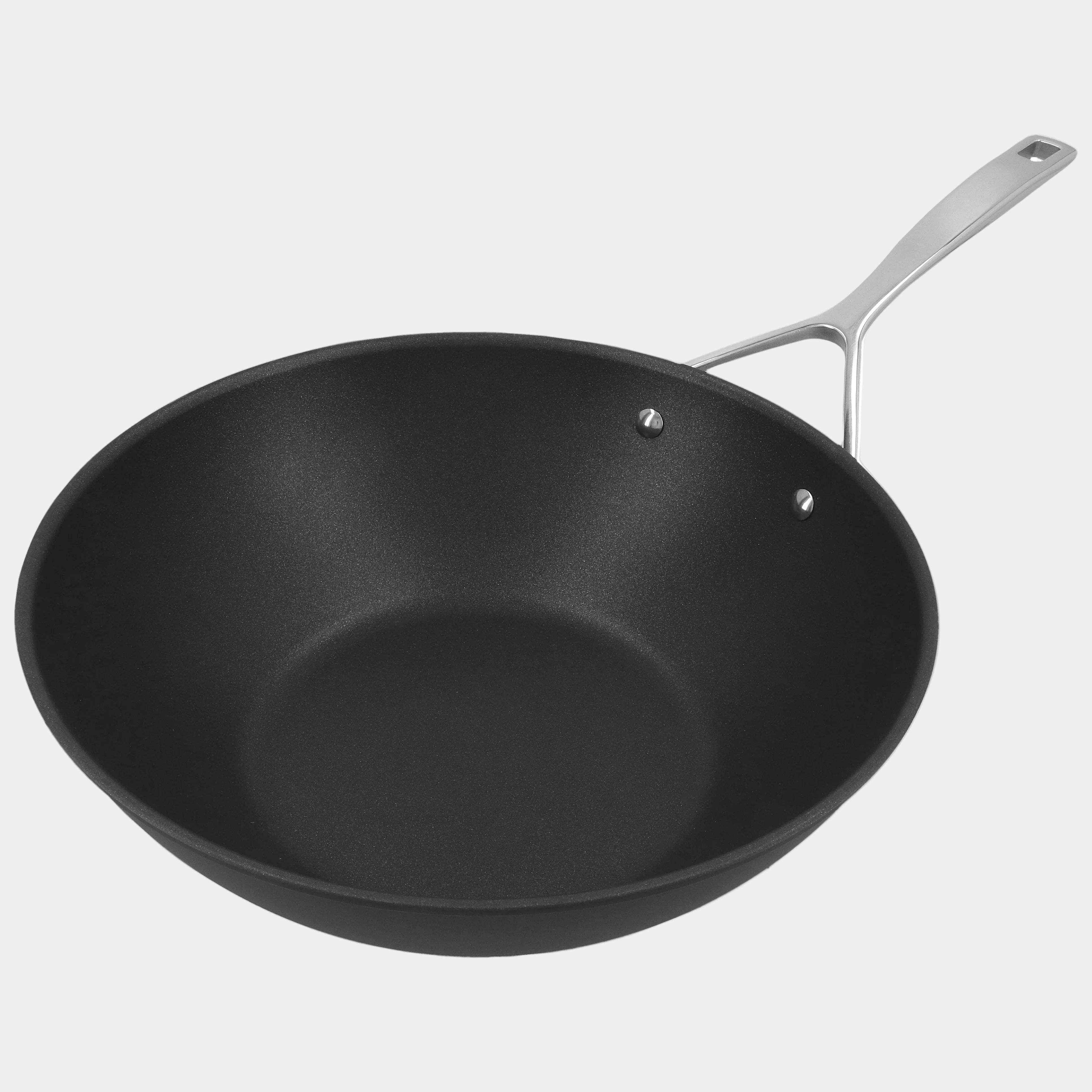 Black frying pan with a silver handle on a white background