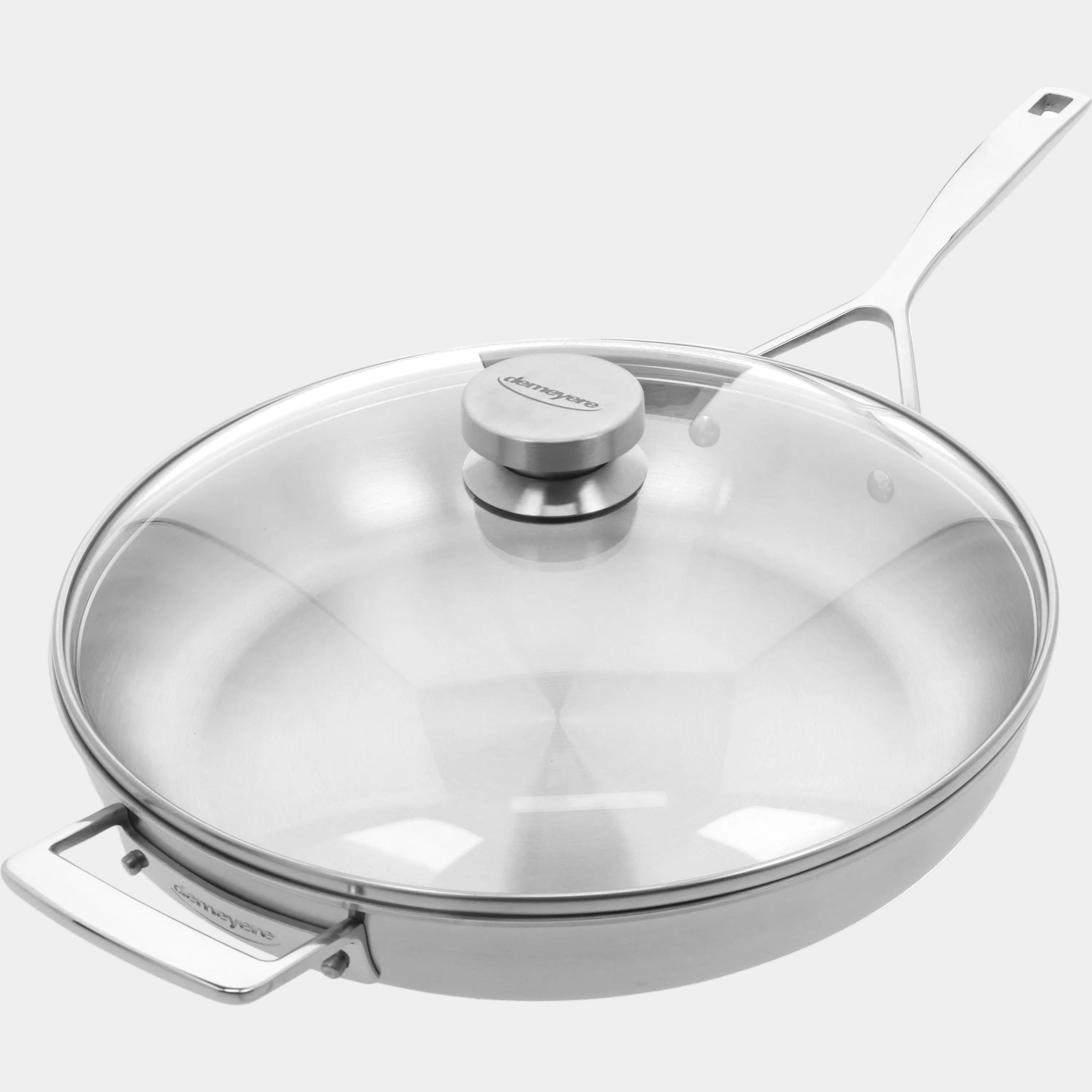 Stainless steel frying pan with glass lid on a white background
