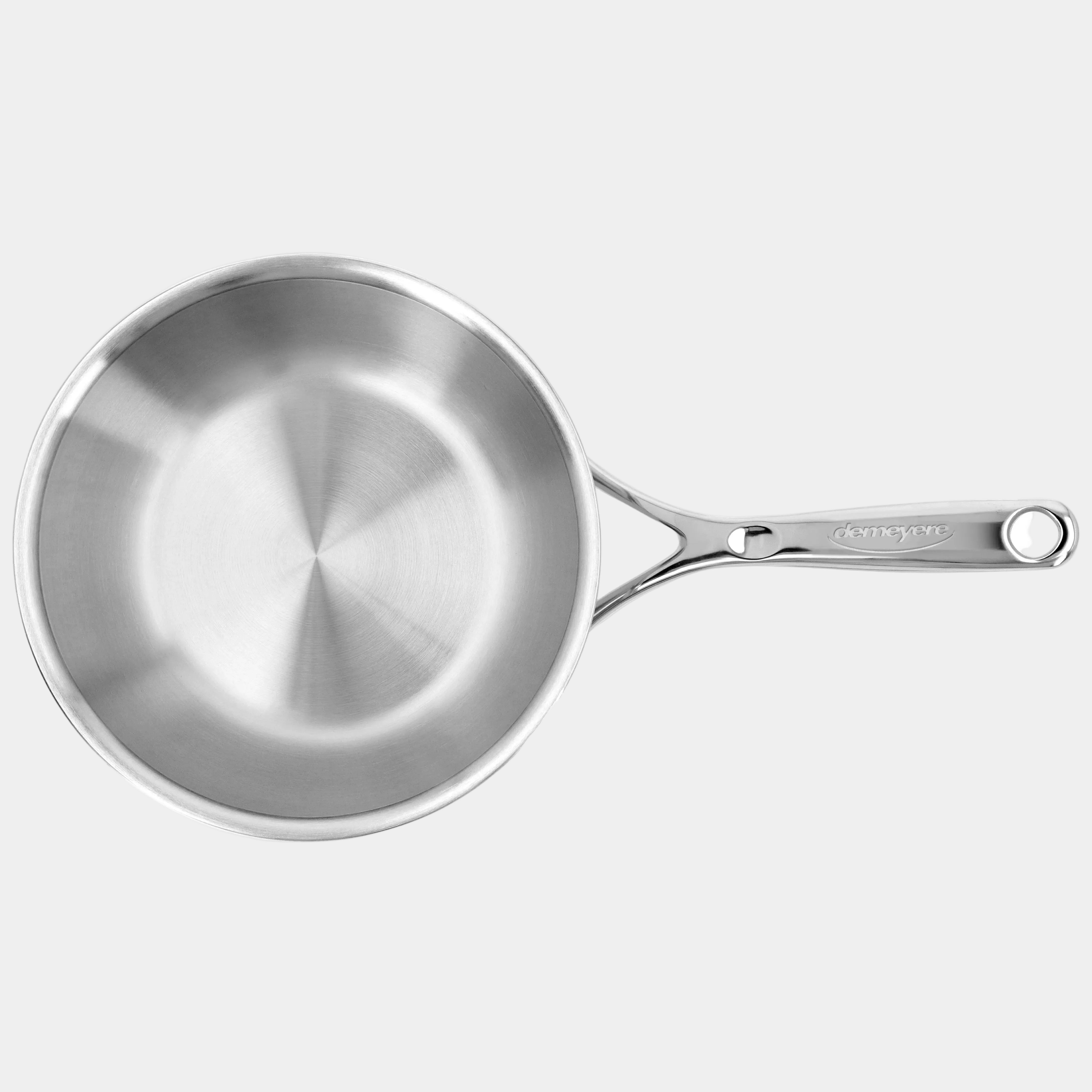 Stainless steel frying pan on a white background