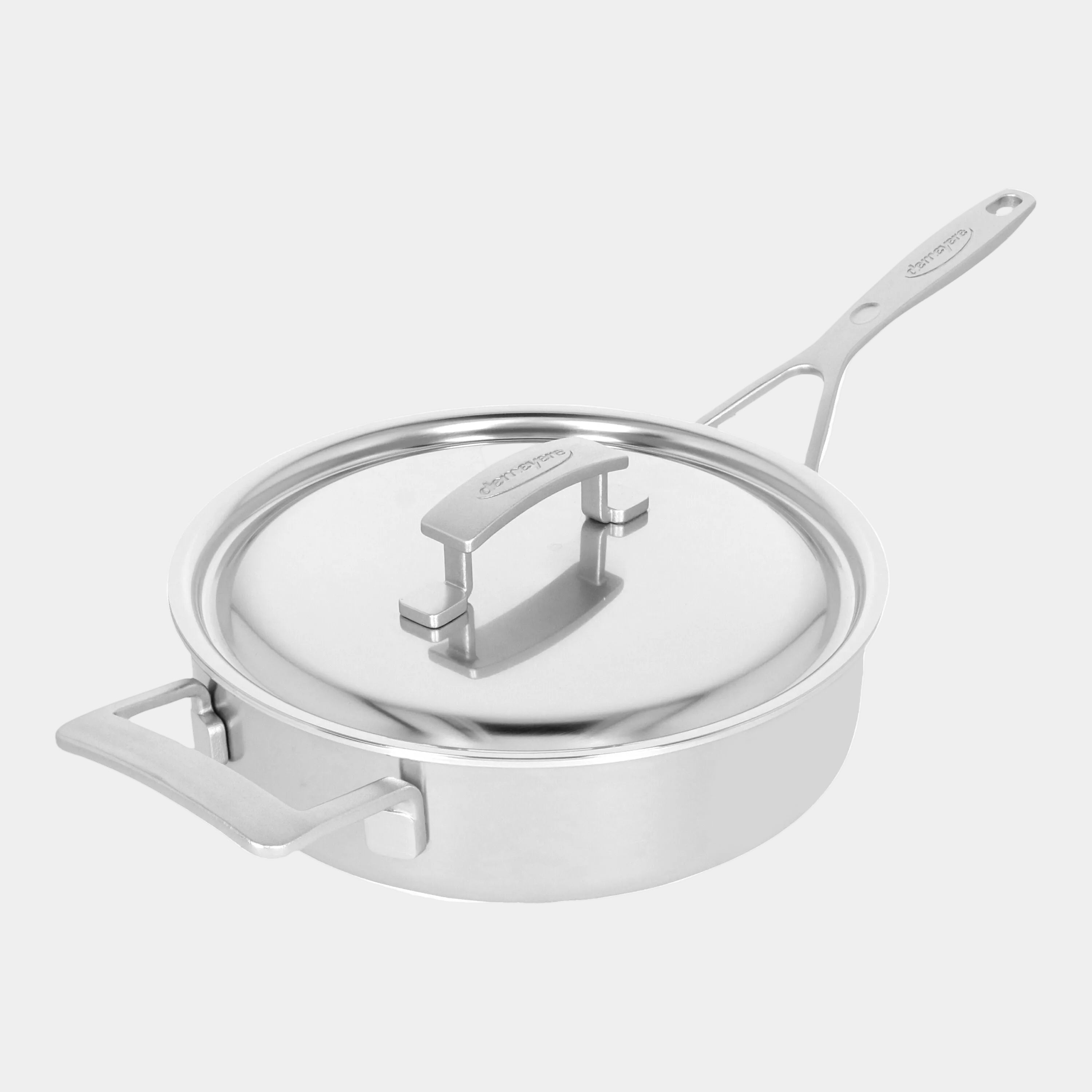 Stainless steel pot with lid on a white background
