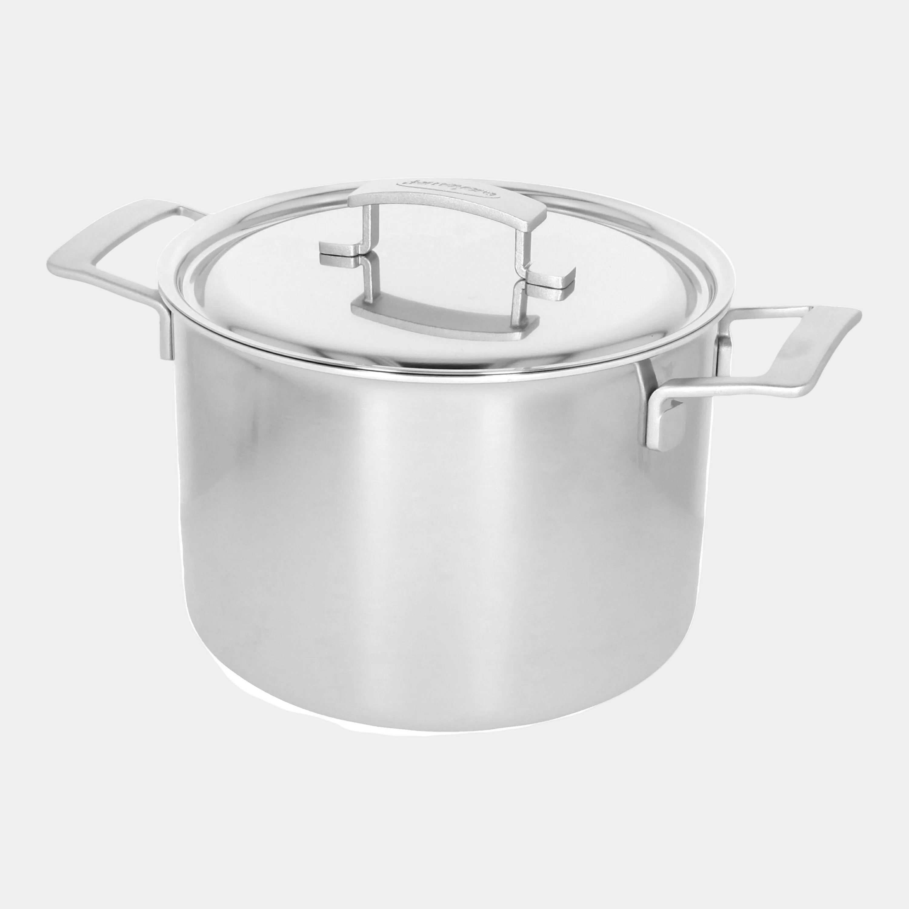 Stainless steel pot with lid on a white background