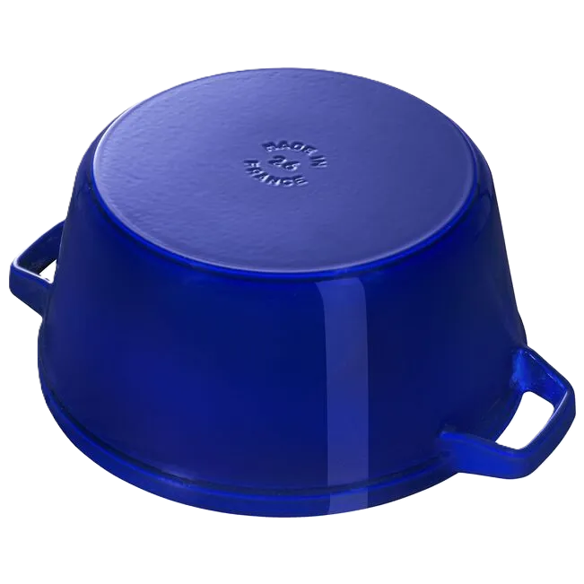 Blue cast iron casserole dish flipped on a white background