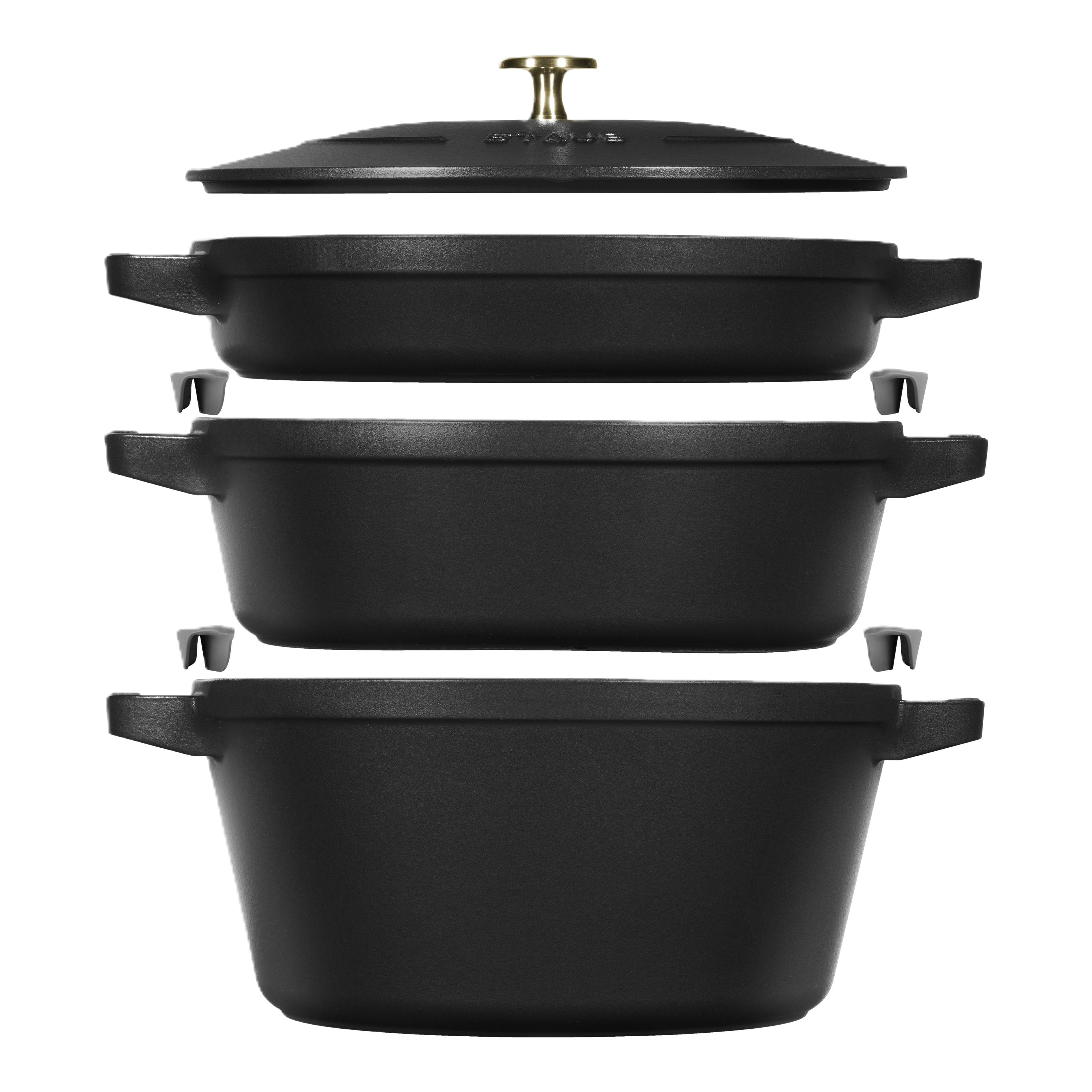 Set of black cast iron cookware pieces on a white background