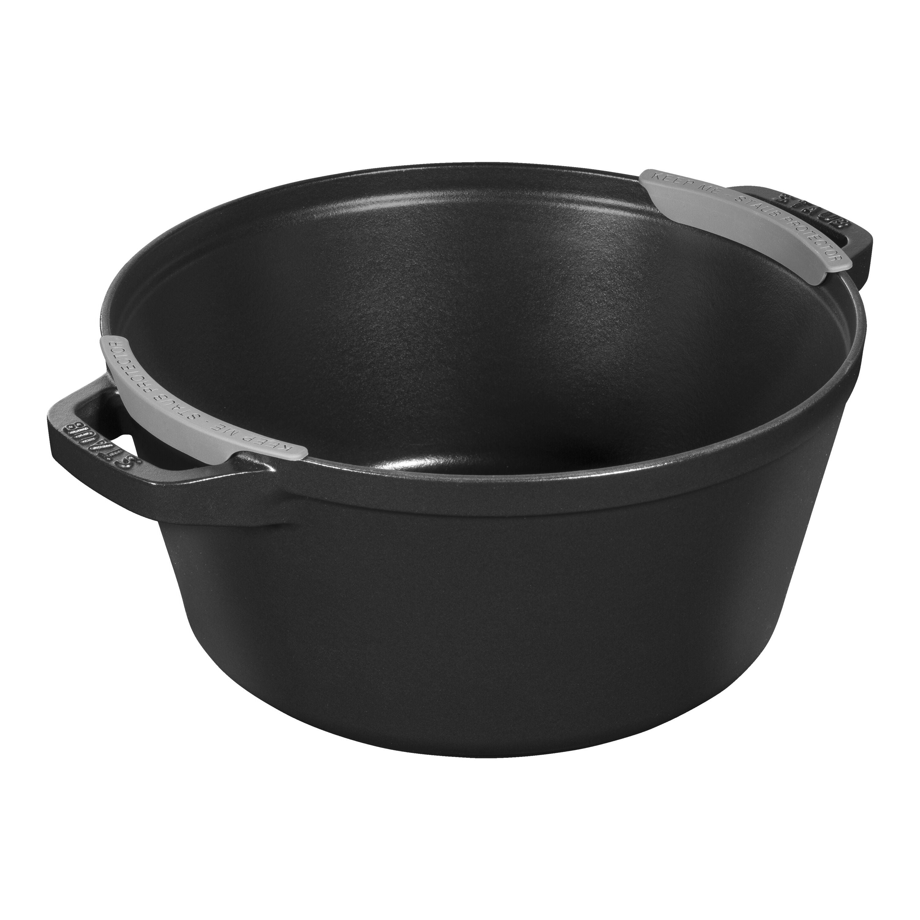 Black cast iron pot with handles on a white background