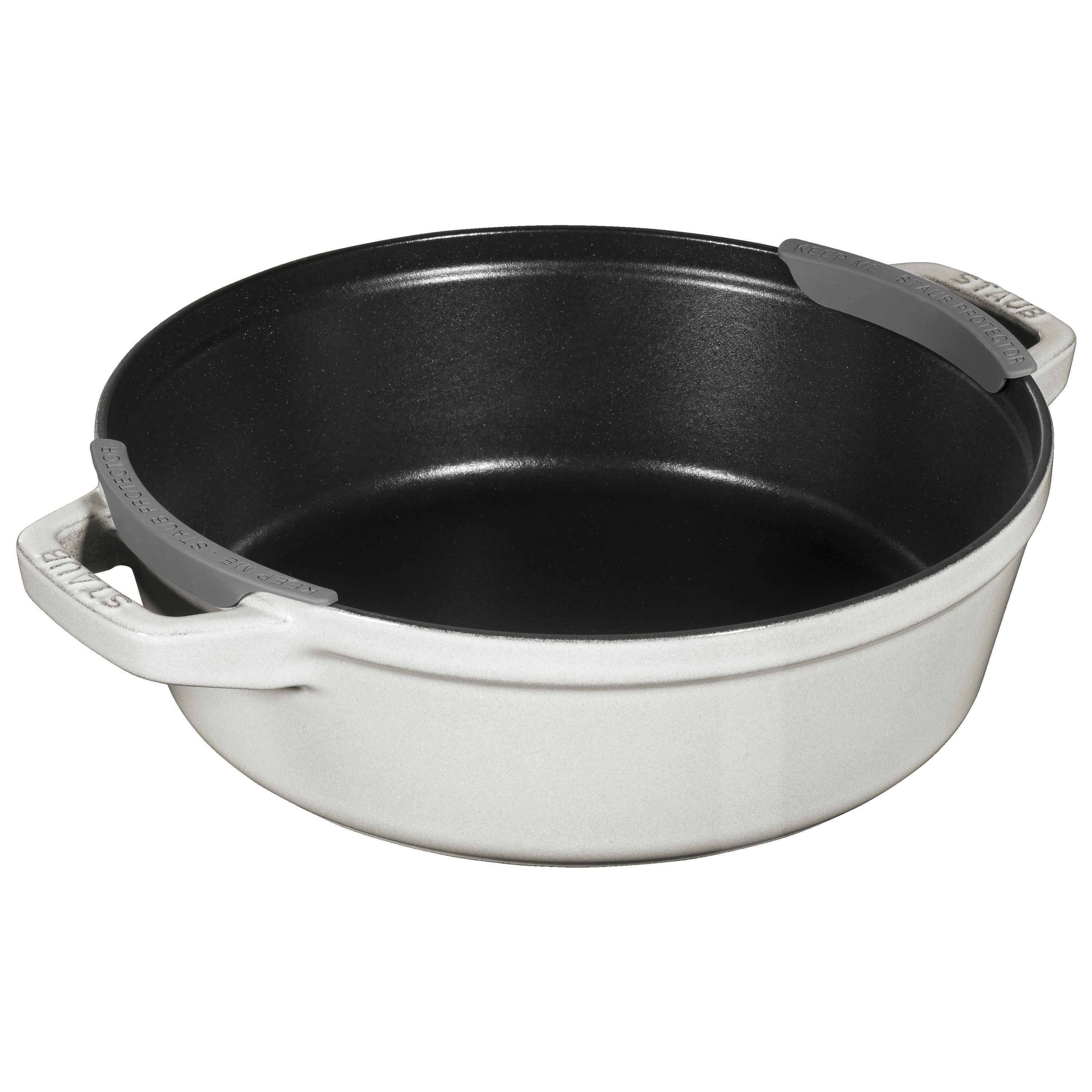 Black cast iron skillet with gray handles on a white background