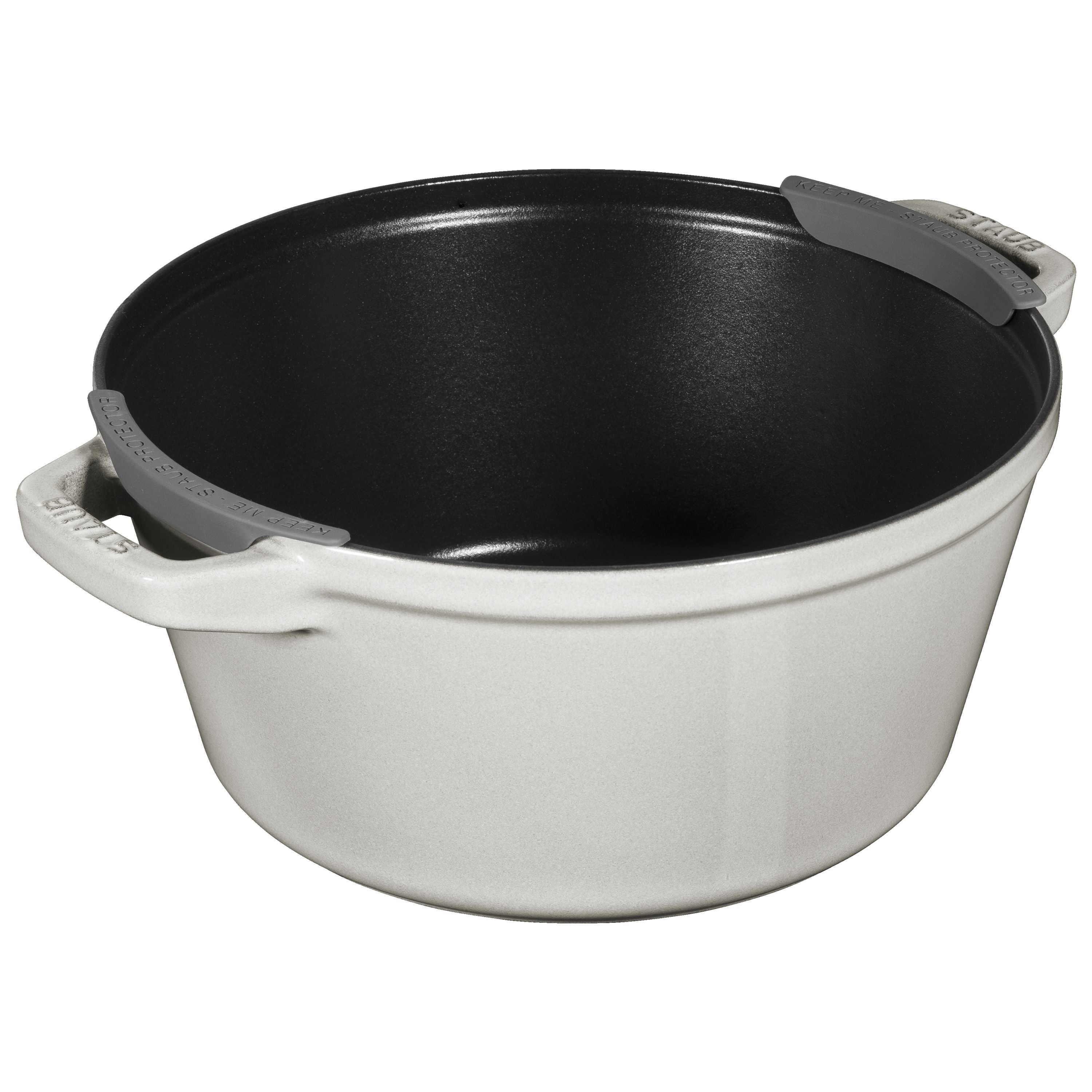 White cast iron pot with black interior on a white background
