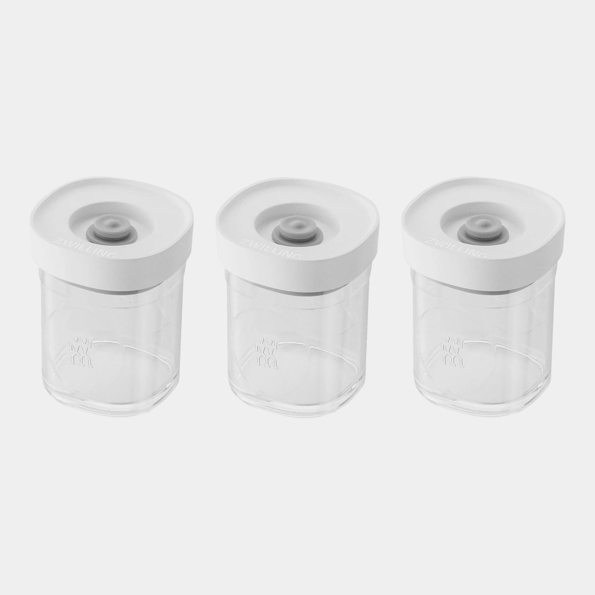 Three clear plastic baby bottles with white screw-on caps, arranged side by side on a plain white background.