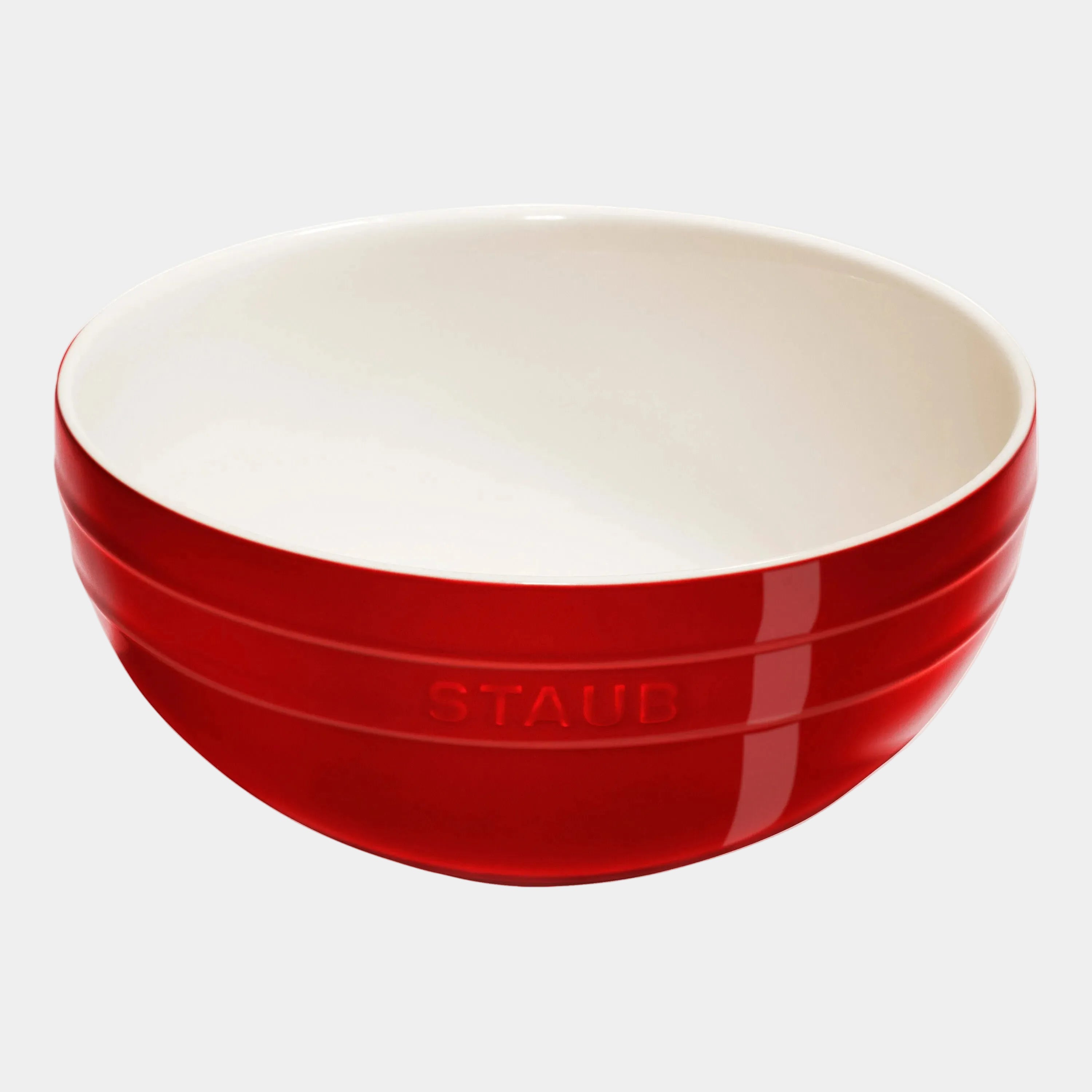 Red and white bowl with 'Staub' branding on a white background