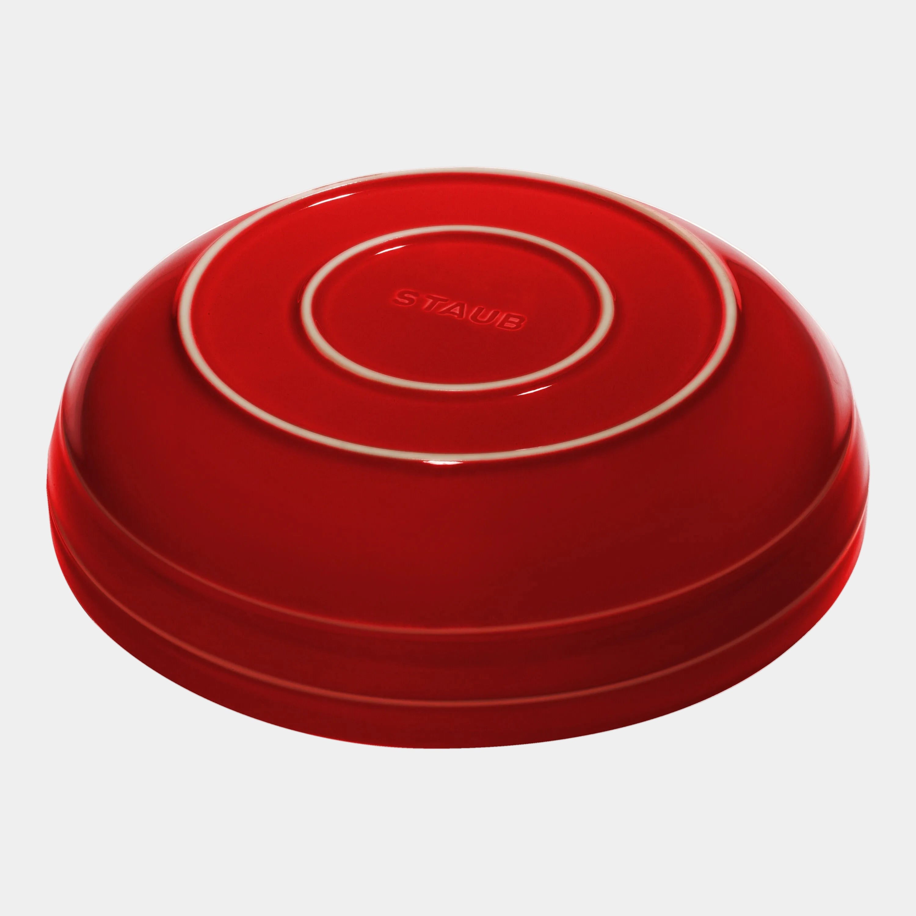 Red lid with 'Staub' branding on a white background