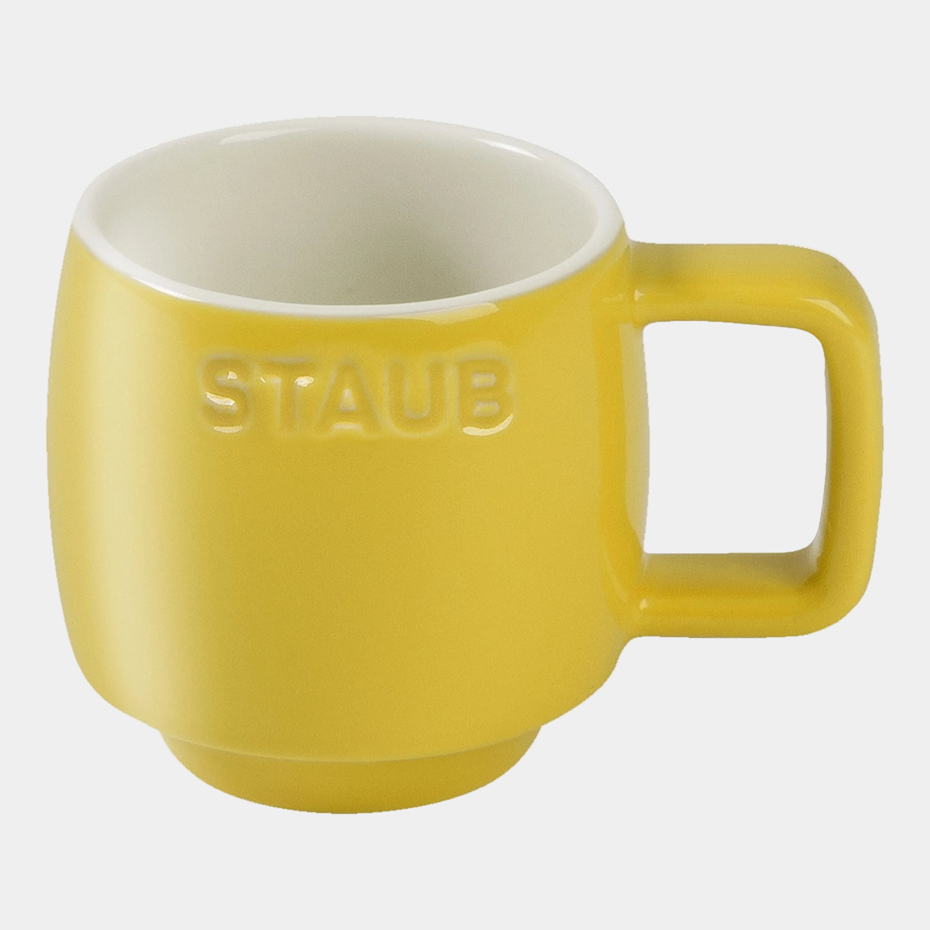 Yellow mug with 'Staub' branding on a white background