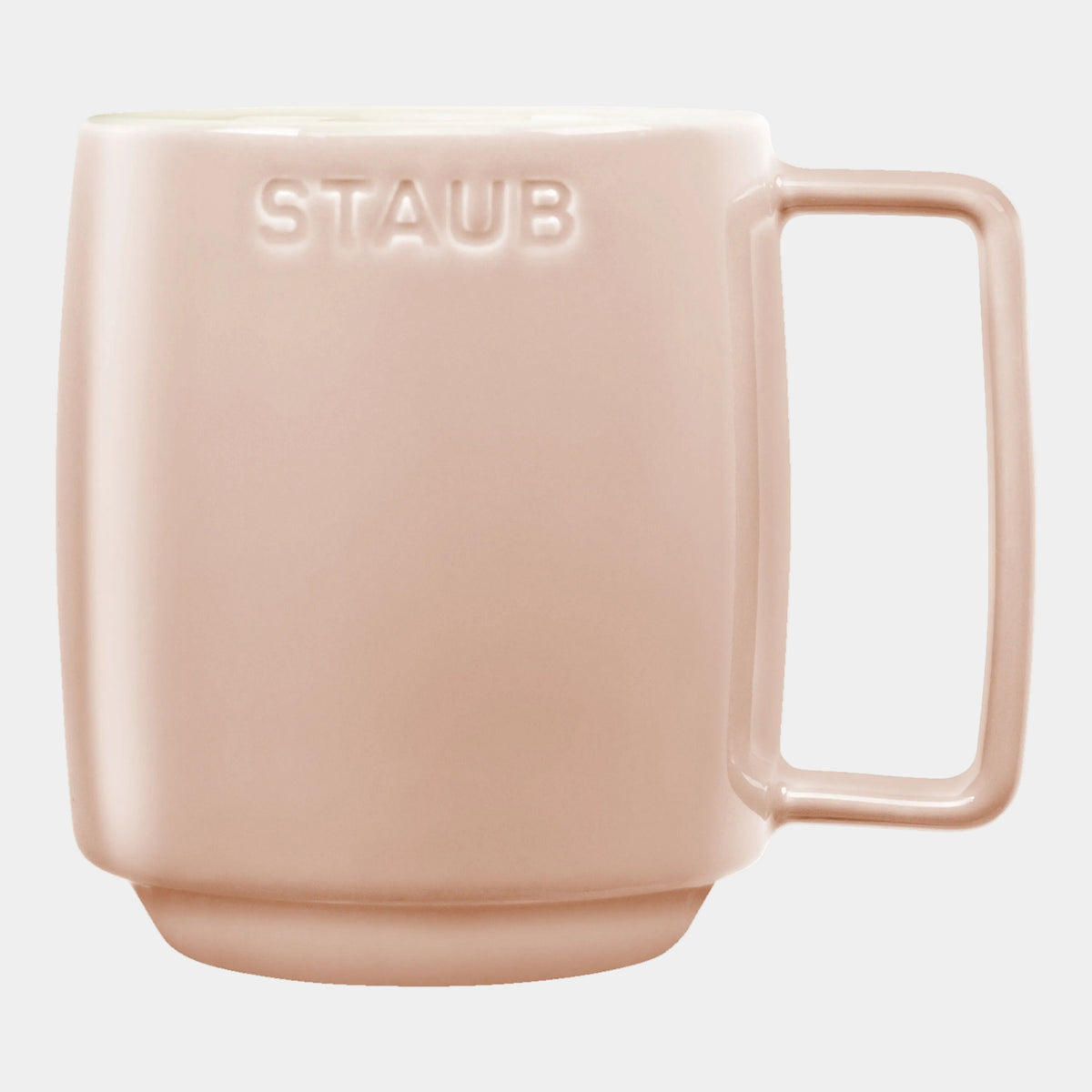 Pink mug with 'STAUB' branding on a white background