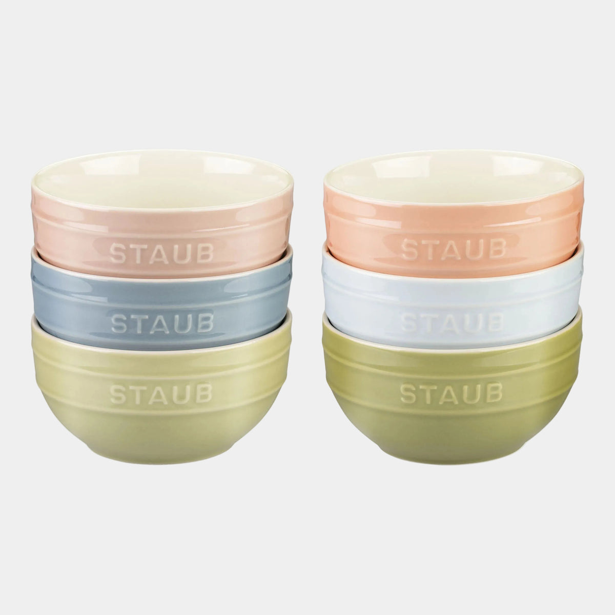 Set of Staub ceramic bowls in pastel colors on a white background