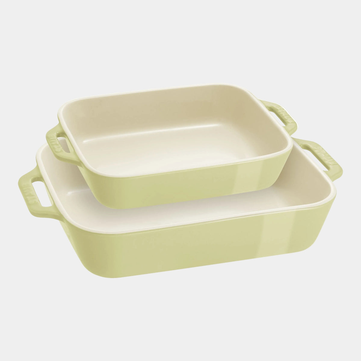 Set of three green rectangular baking dishes on a white background