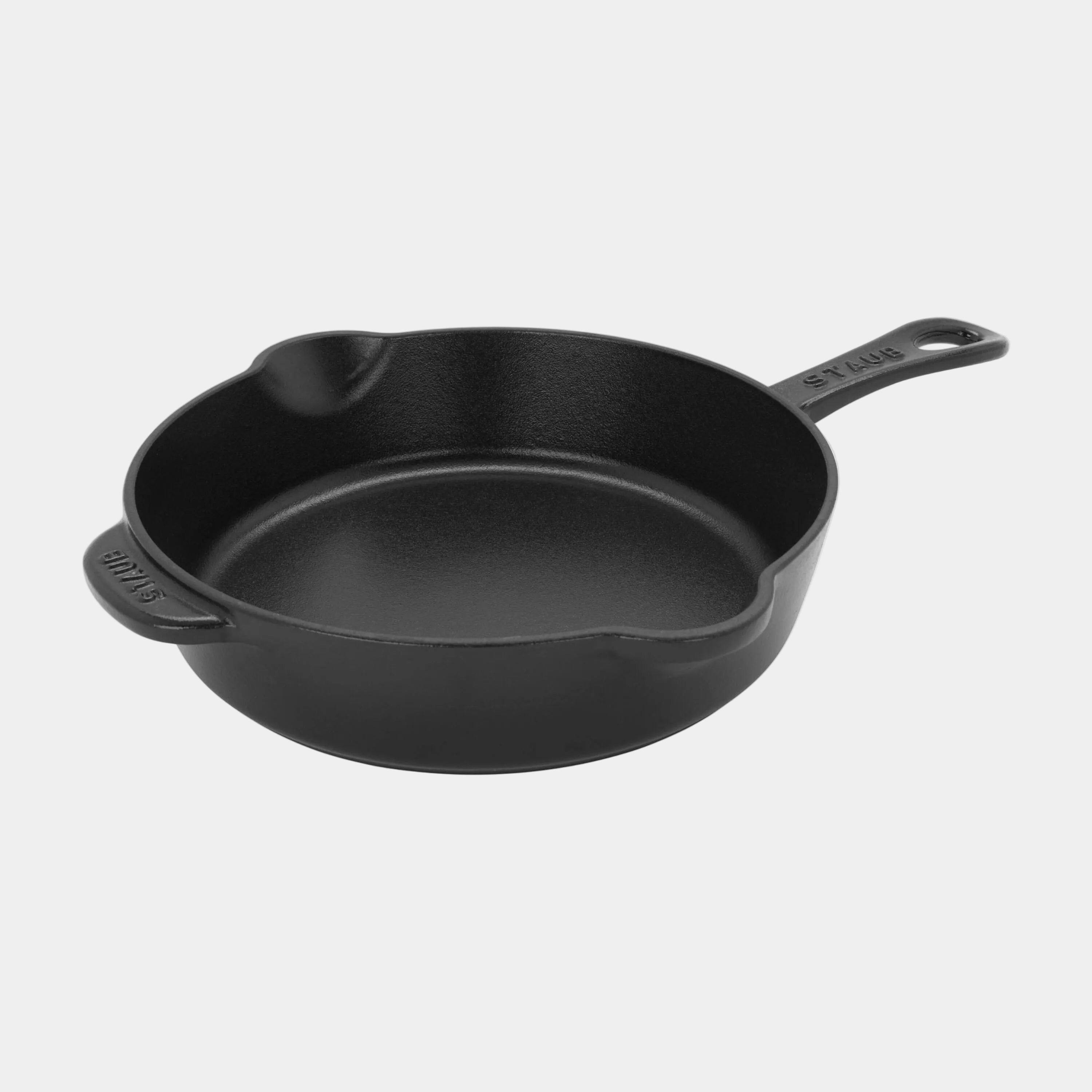Black cast iron skillet on a white background