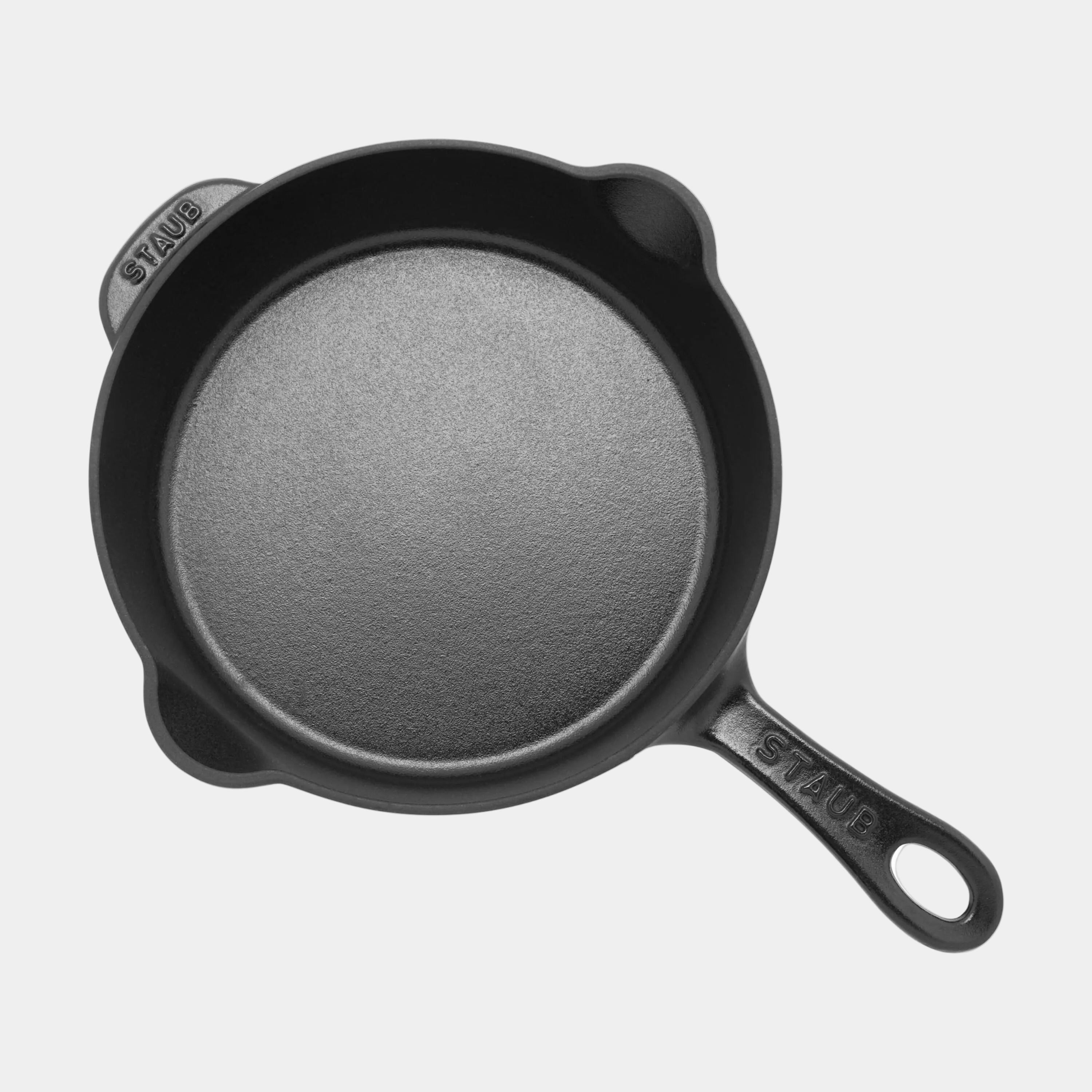 Black cast iron skillet on a white background