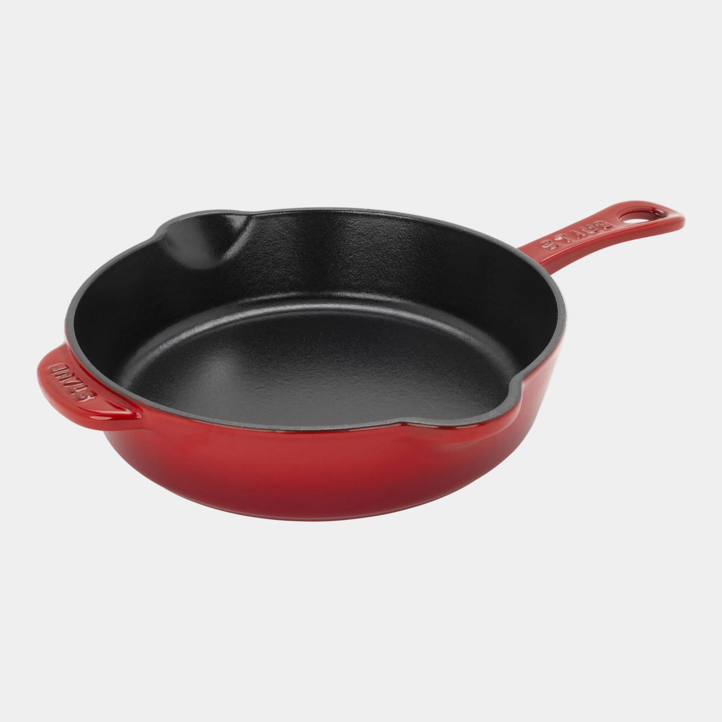 Red cast iron skillet on a white background