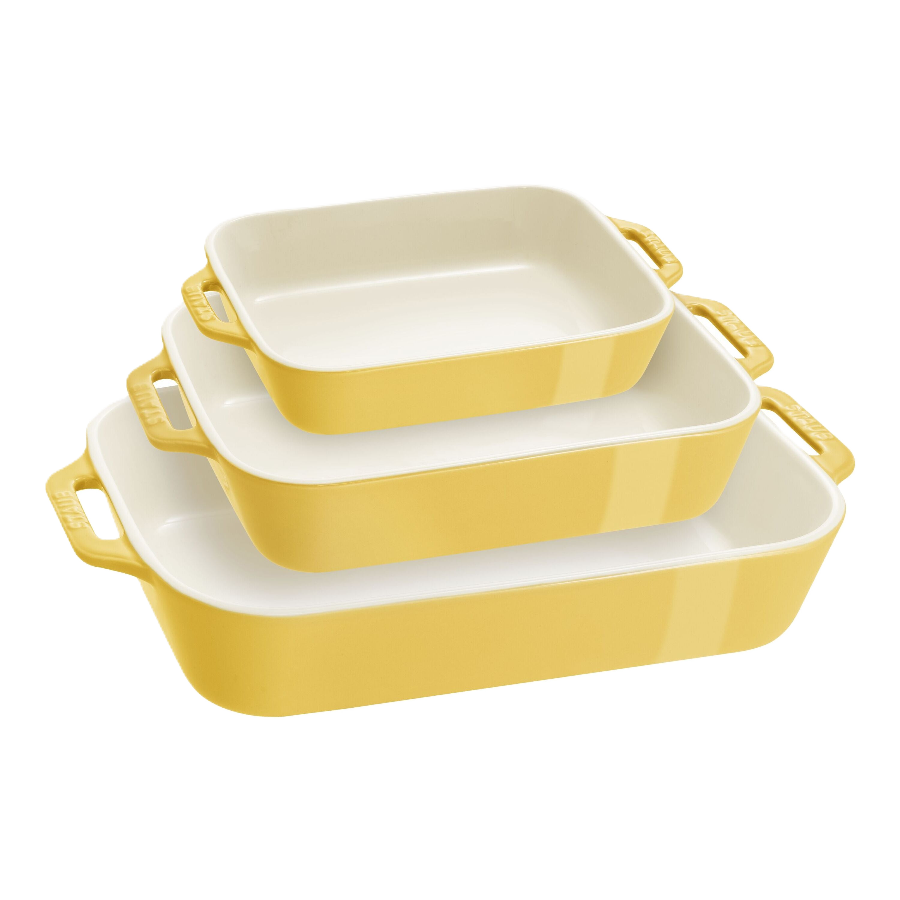 Set of three yellow ceramic baking dishes with handles on a white background