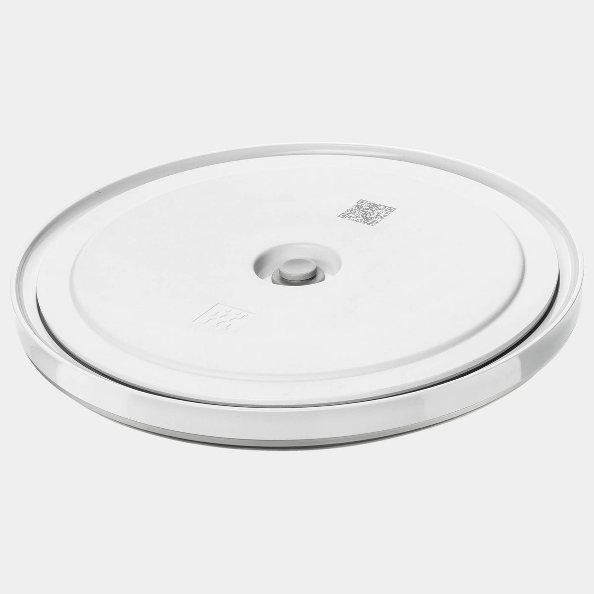 Round white electronic device on a white background