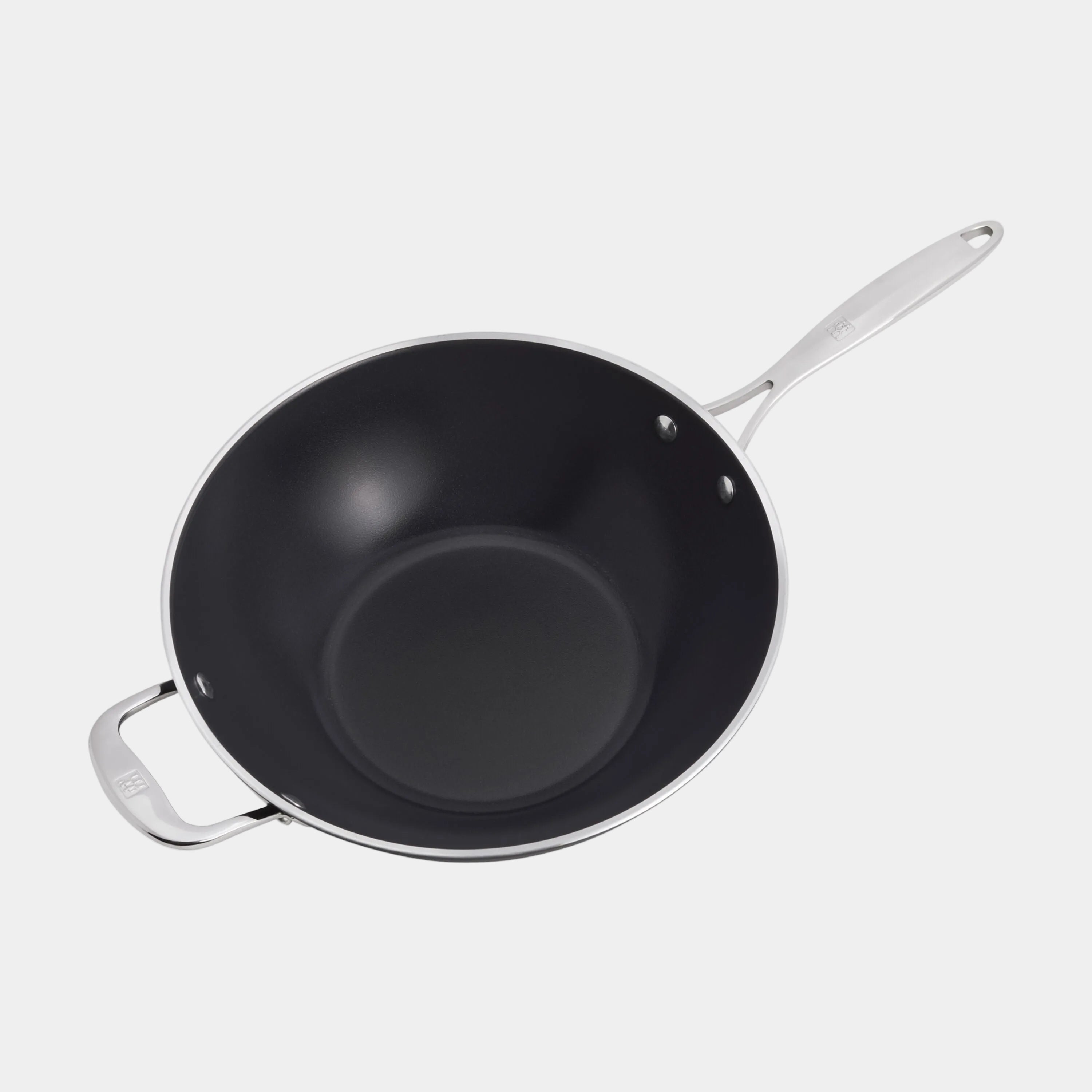 Black wok with silver handles on a white background