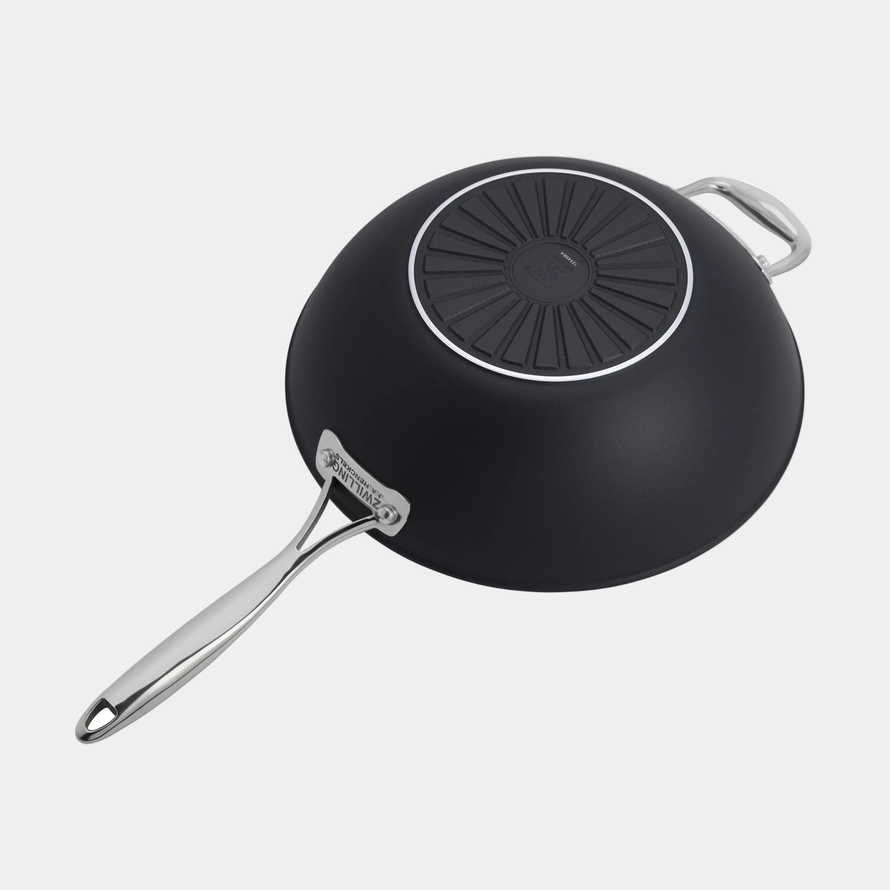 Black frying pan with a silver handle on a white background