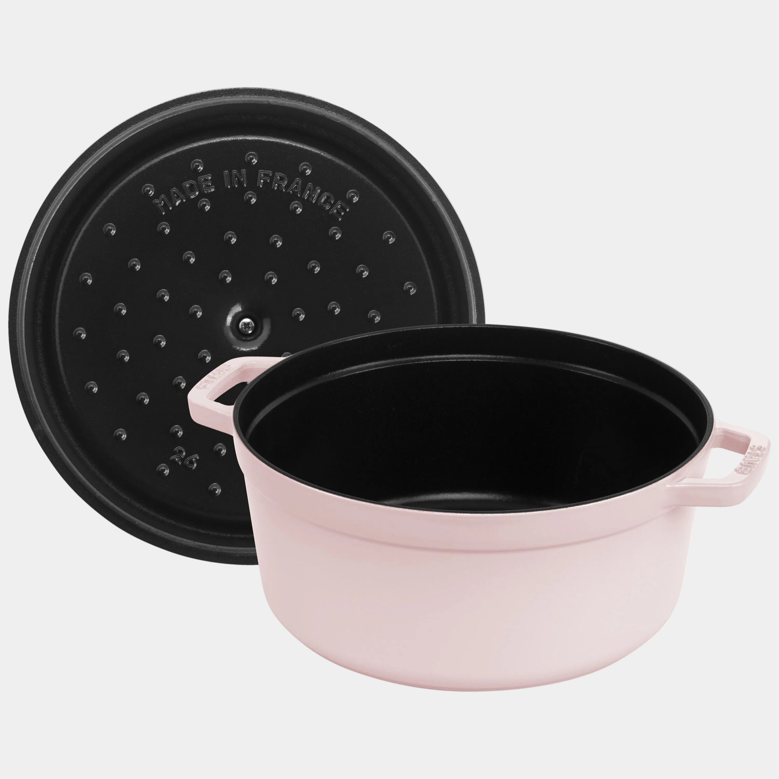Black pot with pink handle and lid on a white background