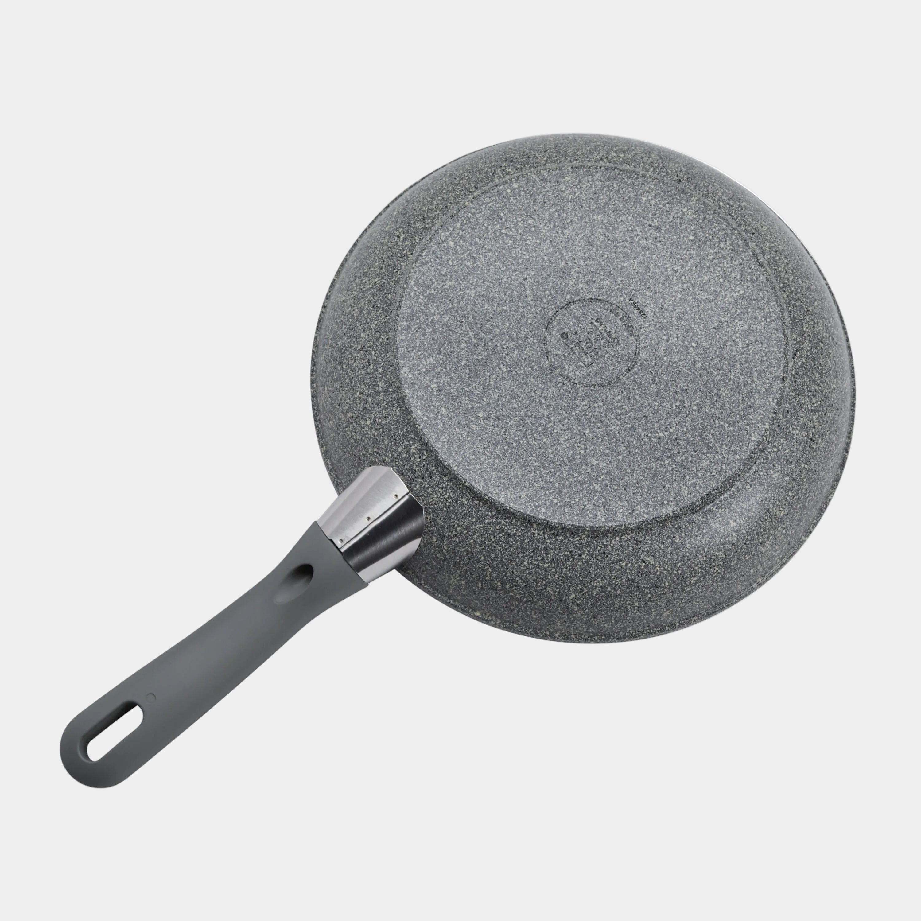 Gray non-stick frying pan with a brush on a white background