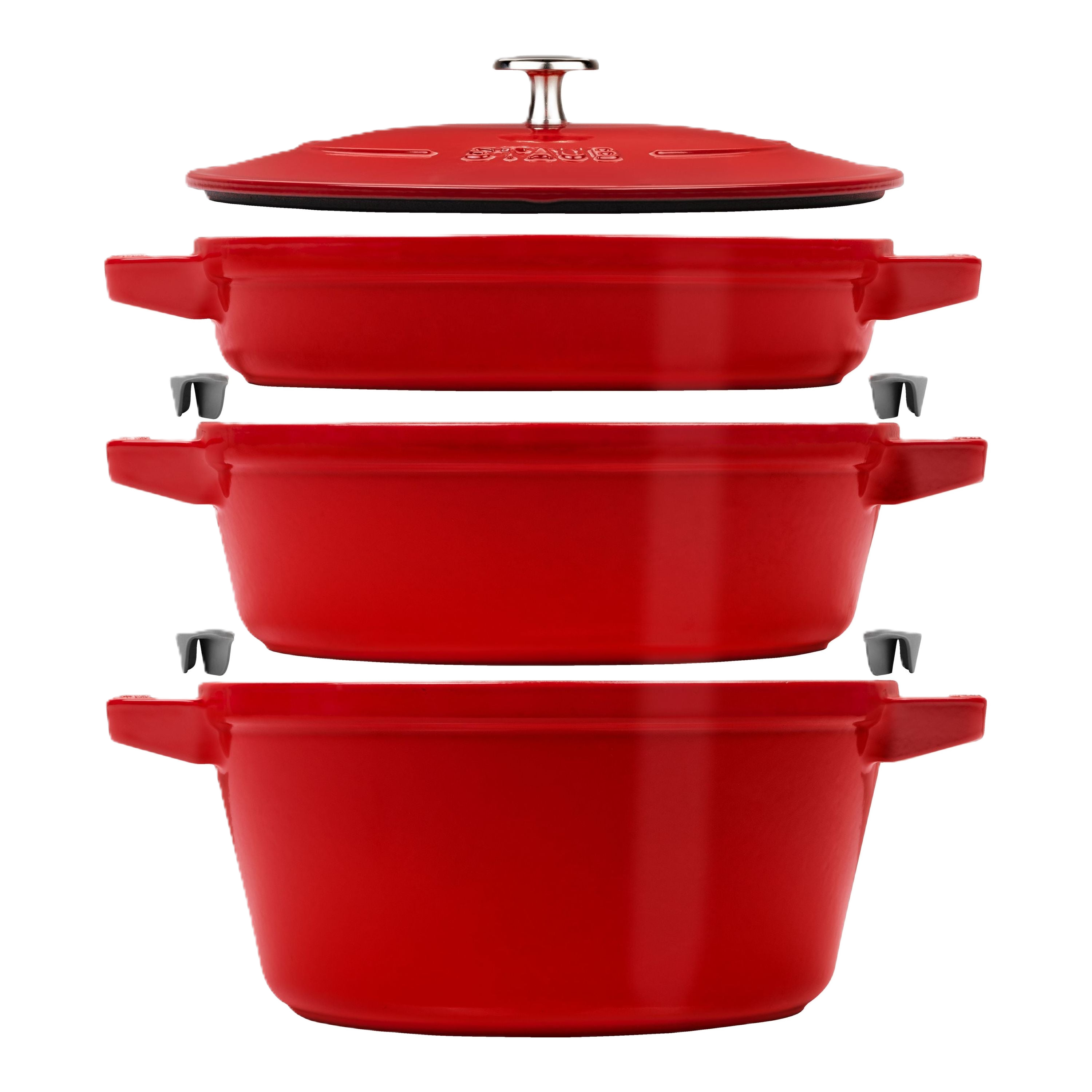 Set of red cookware pots with lids on a white background