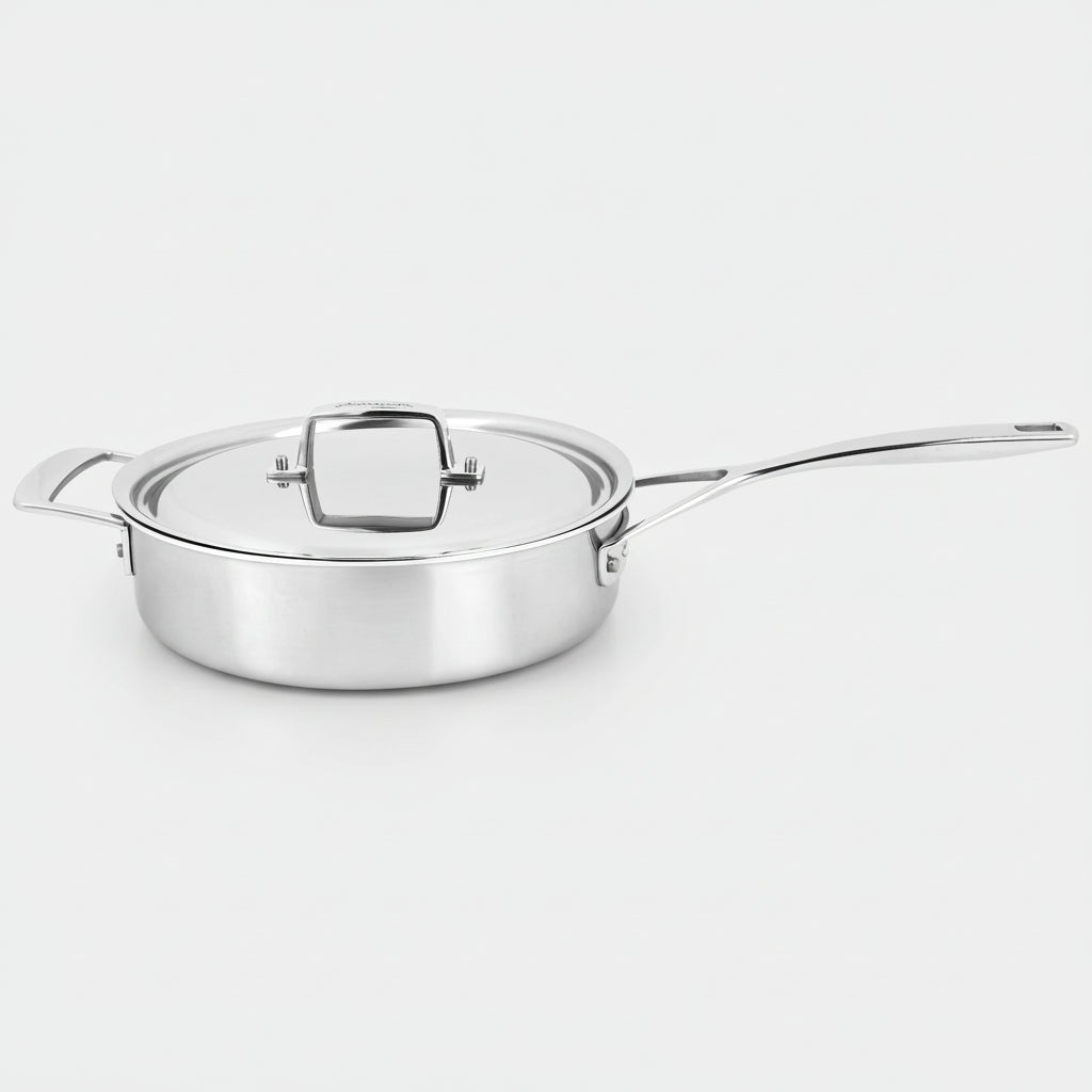 Stainless steel sauté pan with lid on a white background