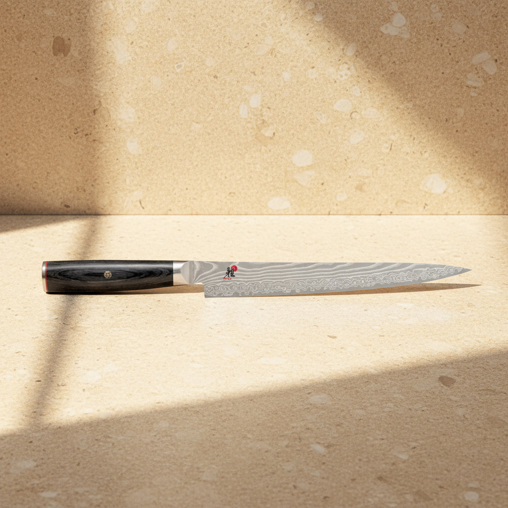 Chef's knife with a black handle on a white background