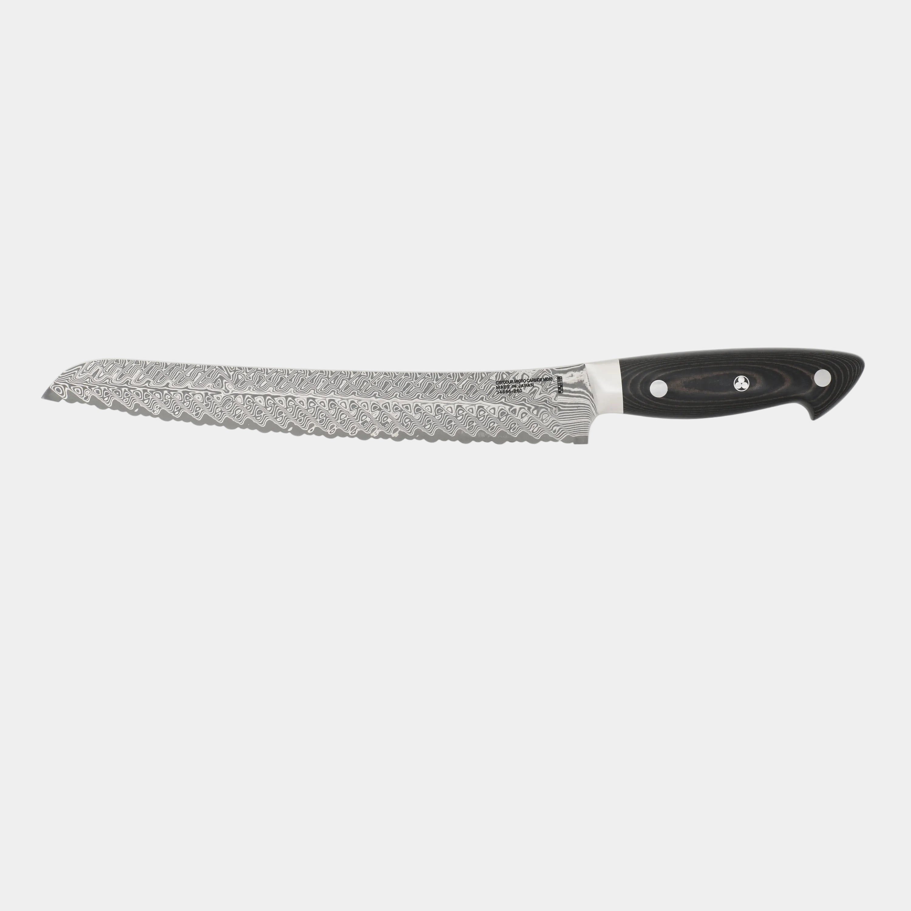 Bread knife with a black handle on a white background
