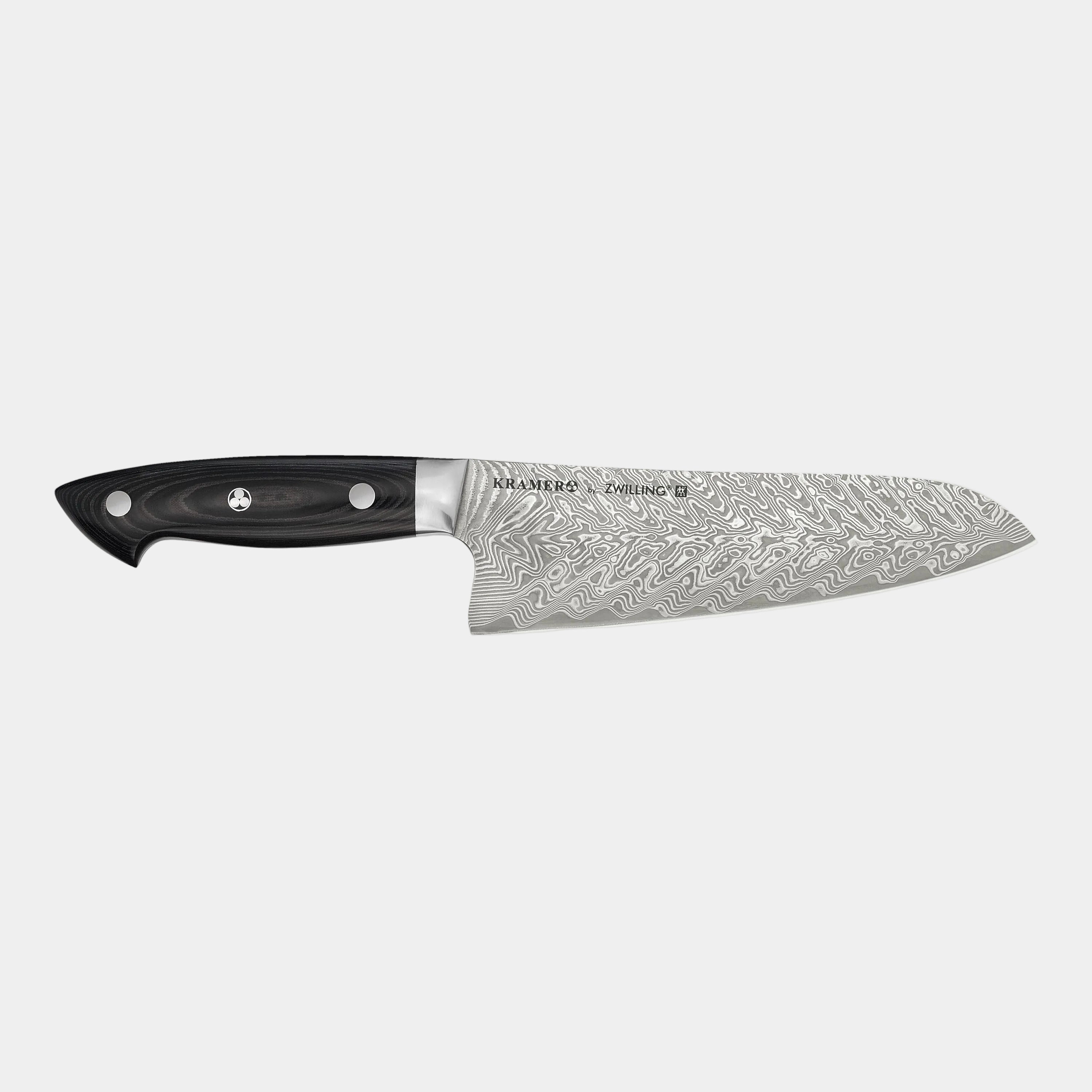 Chef's knife with a black handle and silver blade on a white background