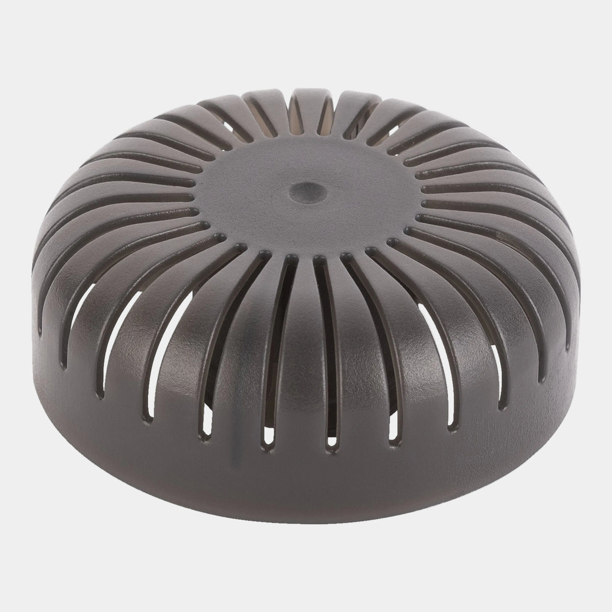 Round metallic object with a textured surface on a white background