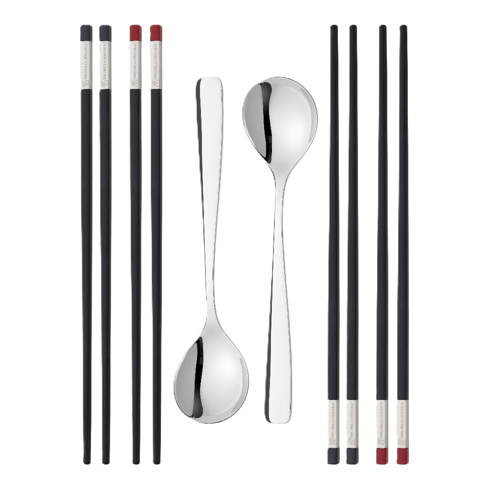 Set of silver cutlery including spoons and chopsticks on a white background