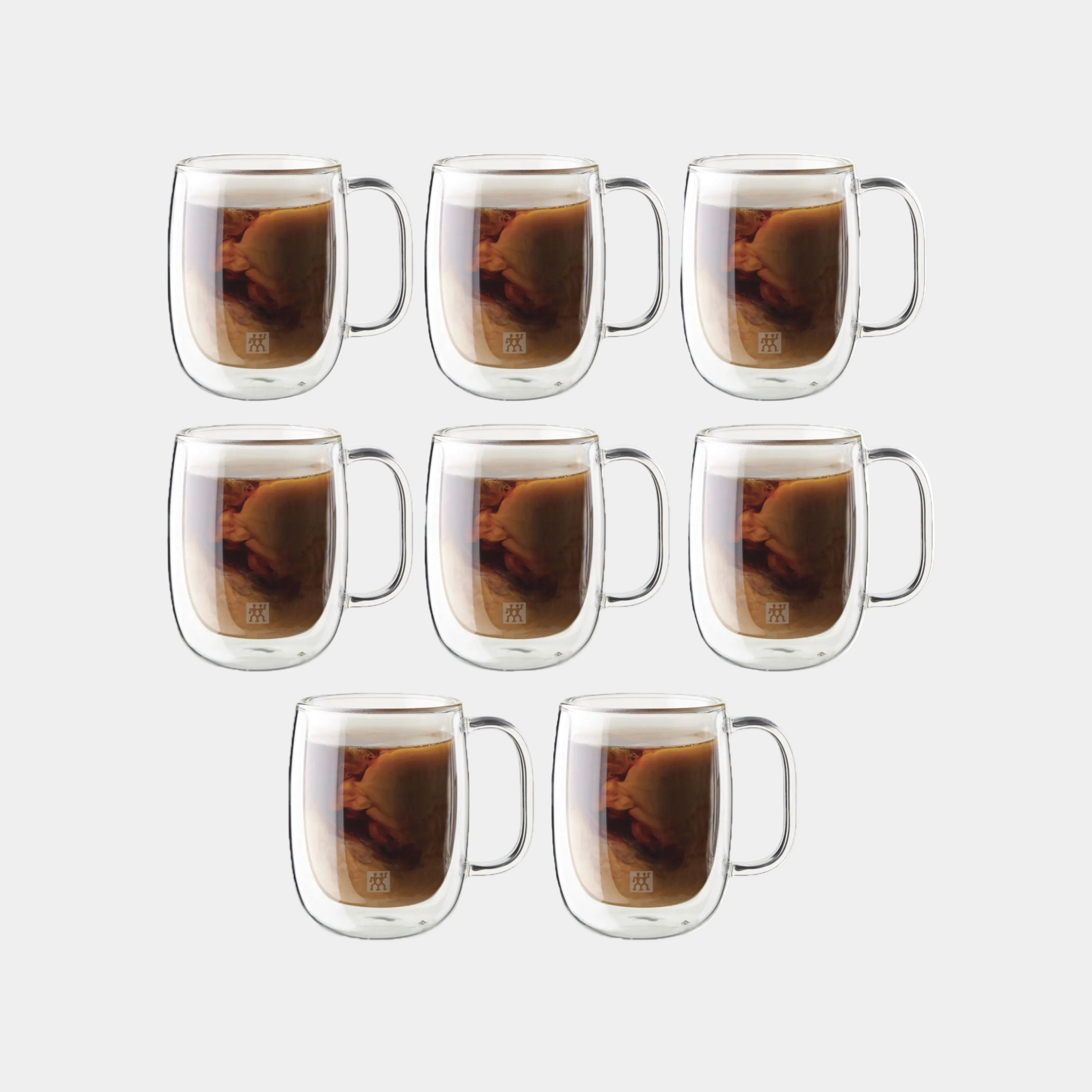 Set of 9 glass mugs with handle, filled with a brown liquid, on a white background.