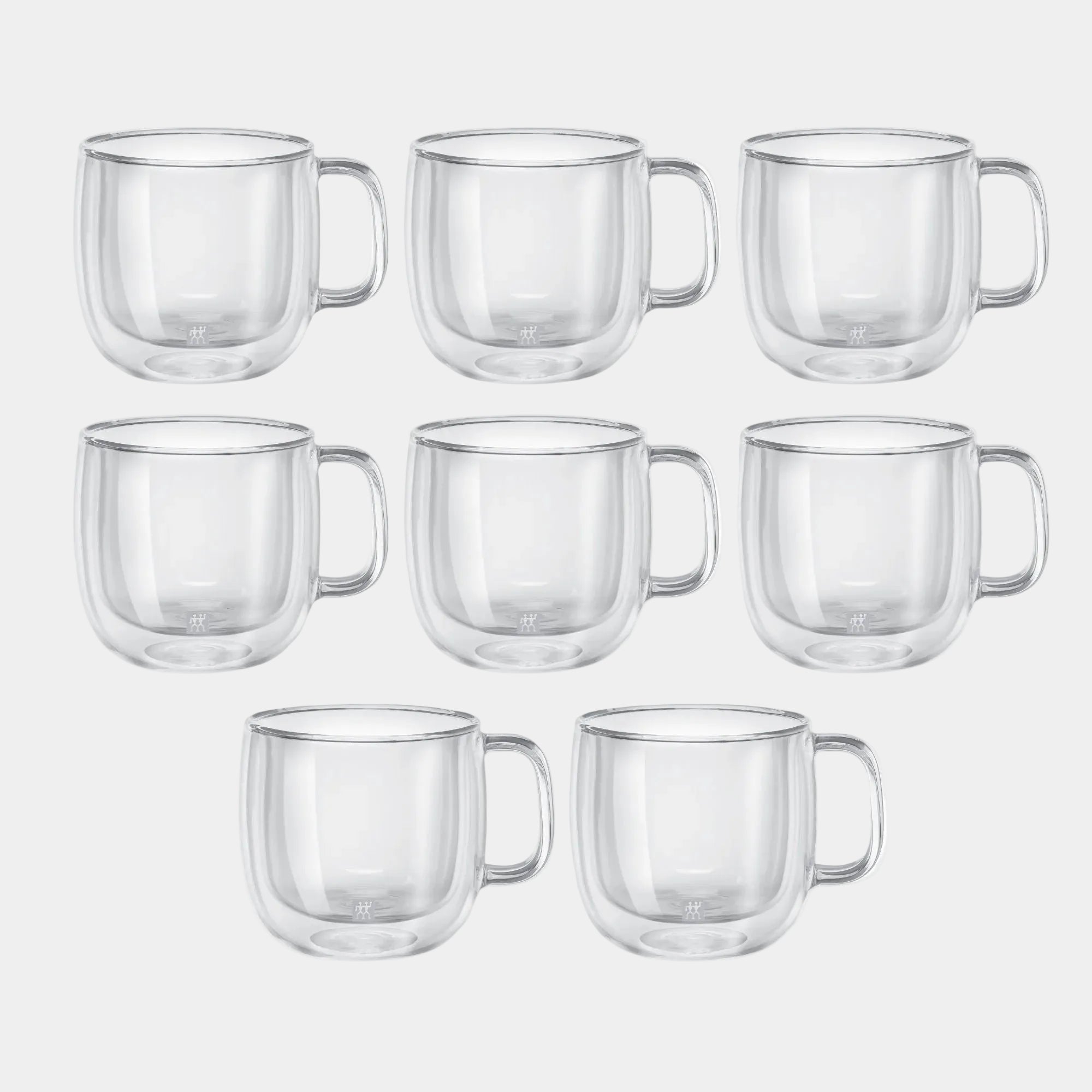 Set of clear glass mugs on a white background
