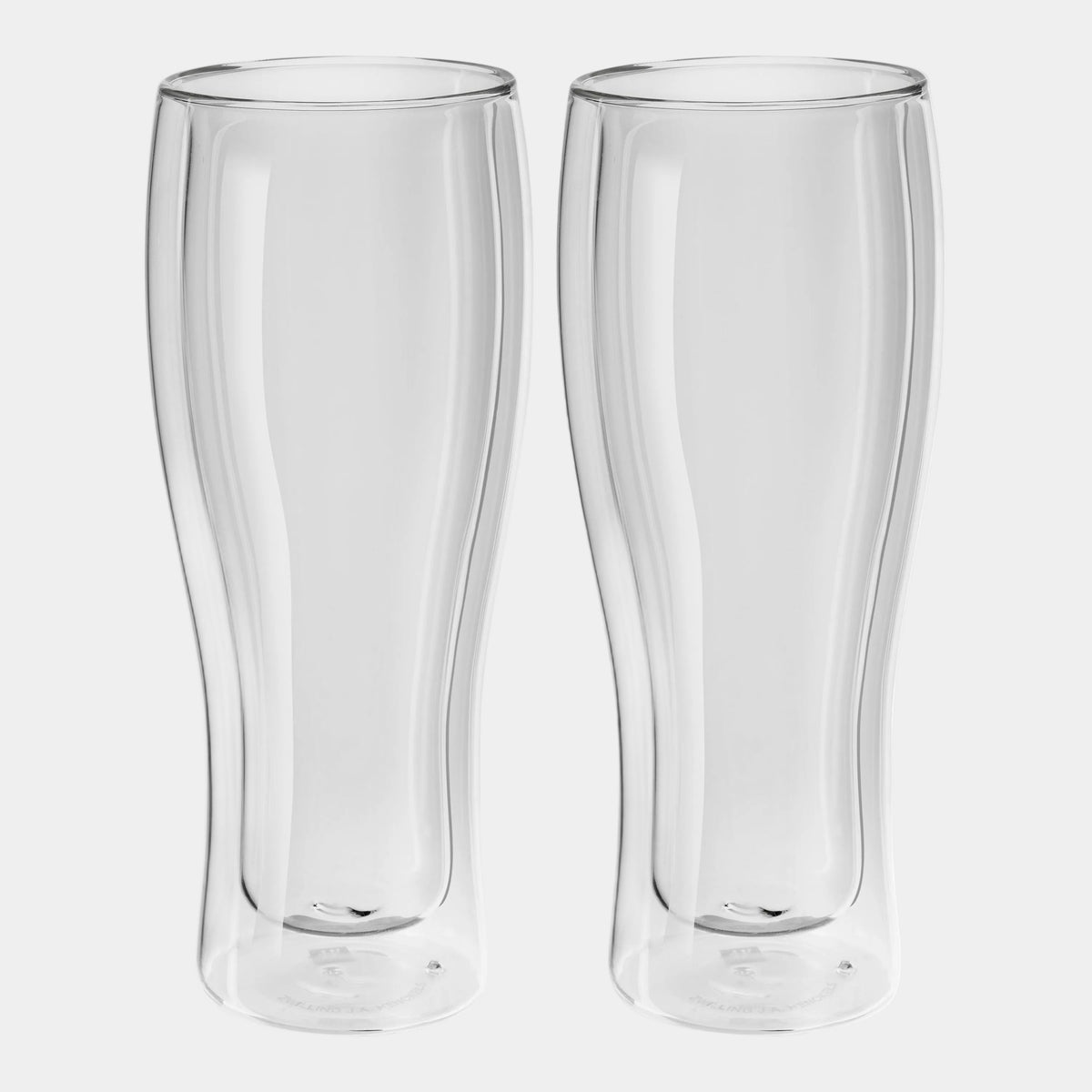 Two clear glass beer steins on a white background