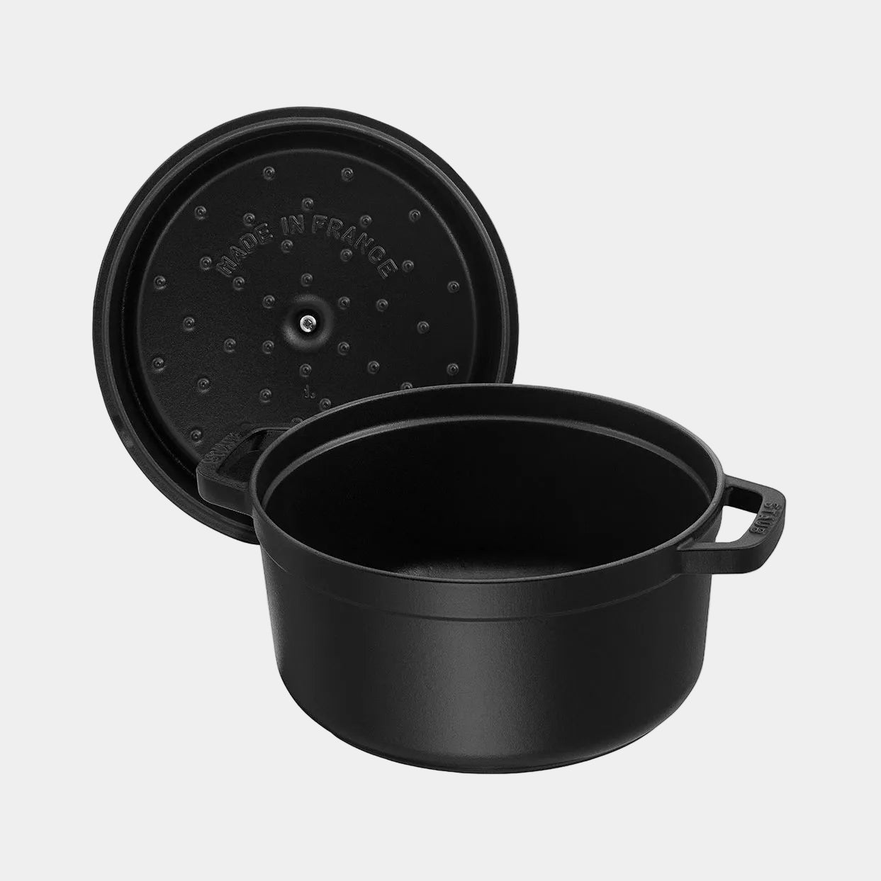 Black cast iron pot with lid on a white background