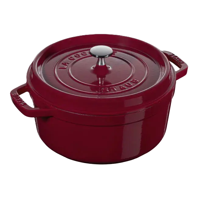 Red Staub cocotte with a silver knob on a white background
